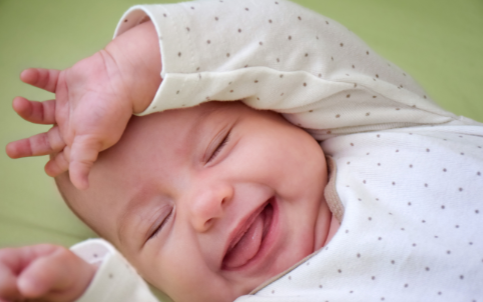 kelowna daycare smiling infant in onesie