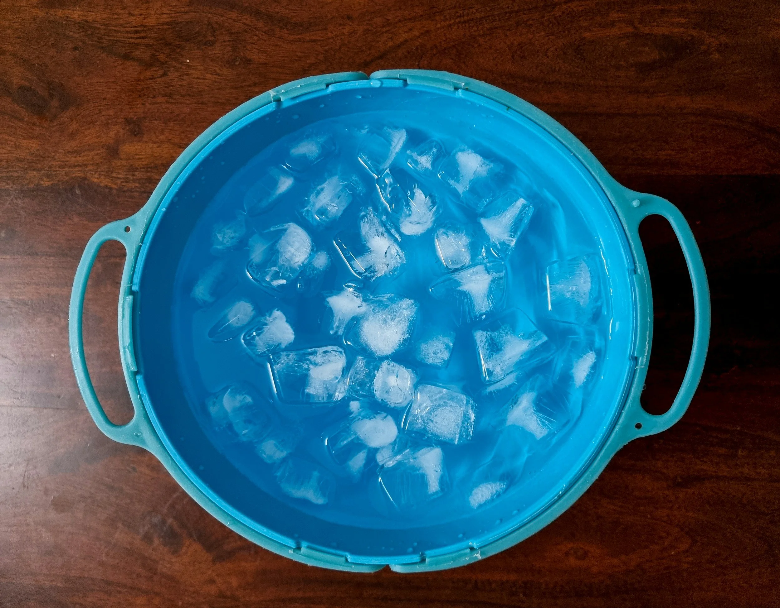 Blue bowl filled with ice water for cold water face dip - a quick nervous system reset tool