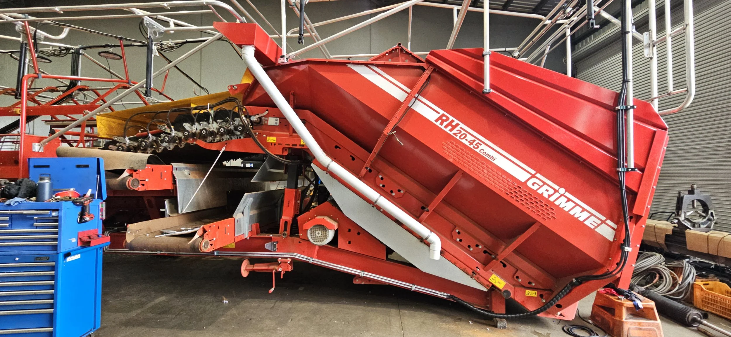 Large red Grimme RH20-45 Combi agricultural machine with 2 100mm downpipes instaled.