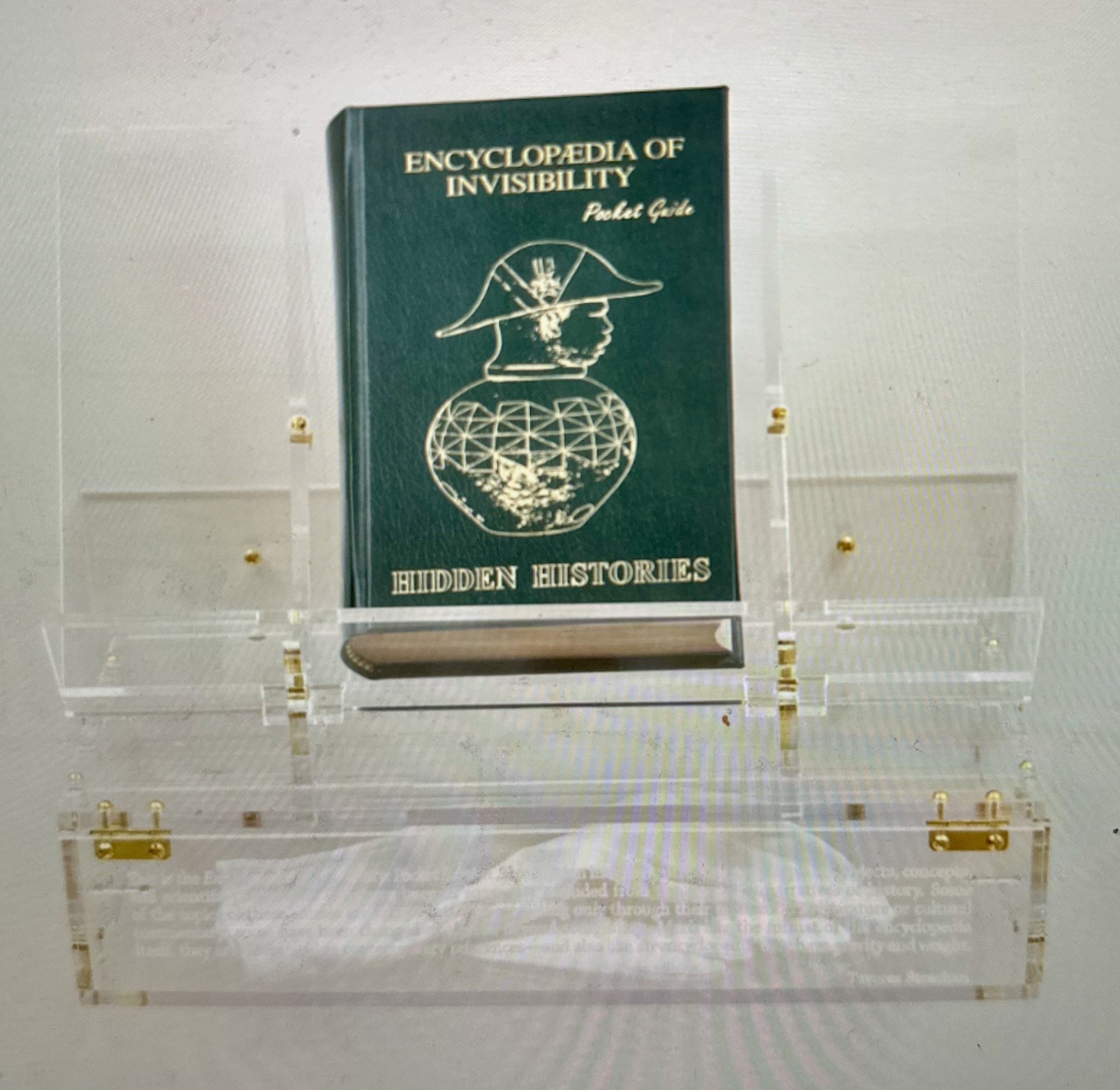 Tavares Strachan, Encyclopedia of Invisibility (Pocket Guide), 2024. Leather, gilding, archival paper, lucite box
and stand. Edition #45/250.