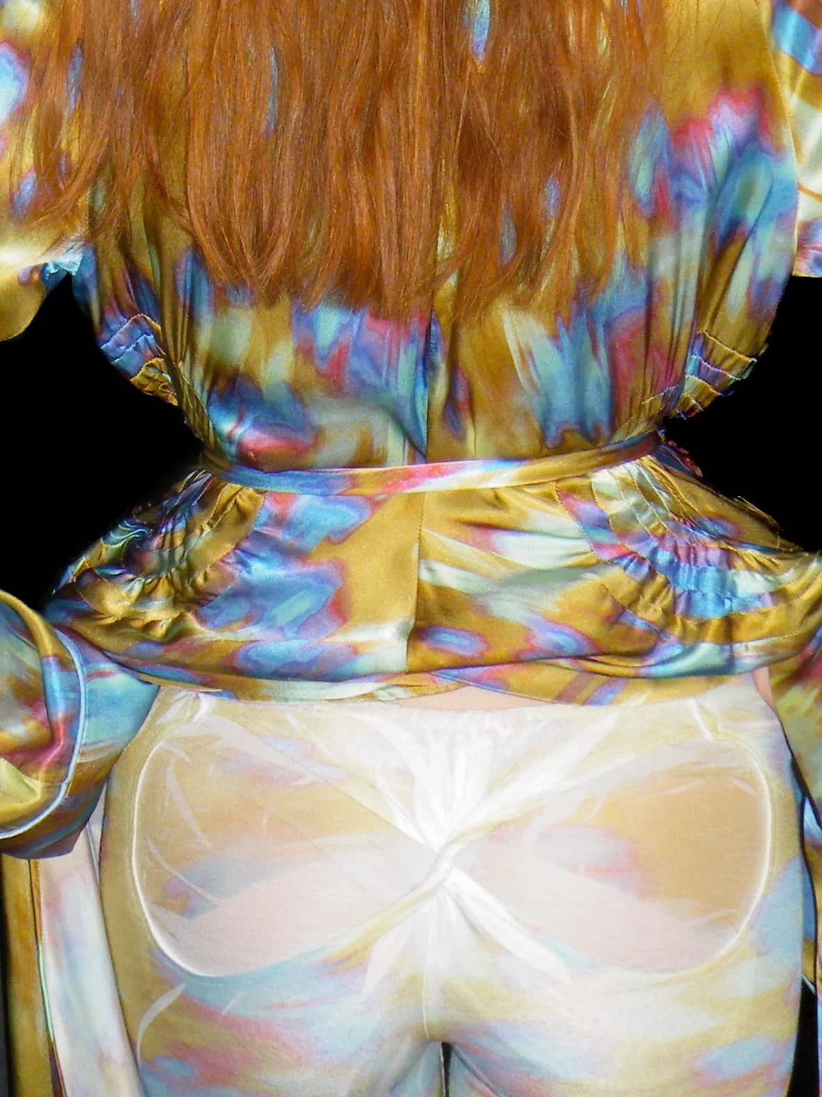 Close-up fashion detail of colourful printed trousers and a matching ruffled top from the Masha Popova AW26 collection during London Fashion Week.