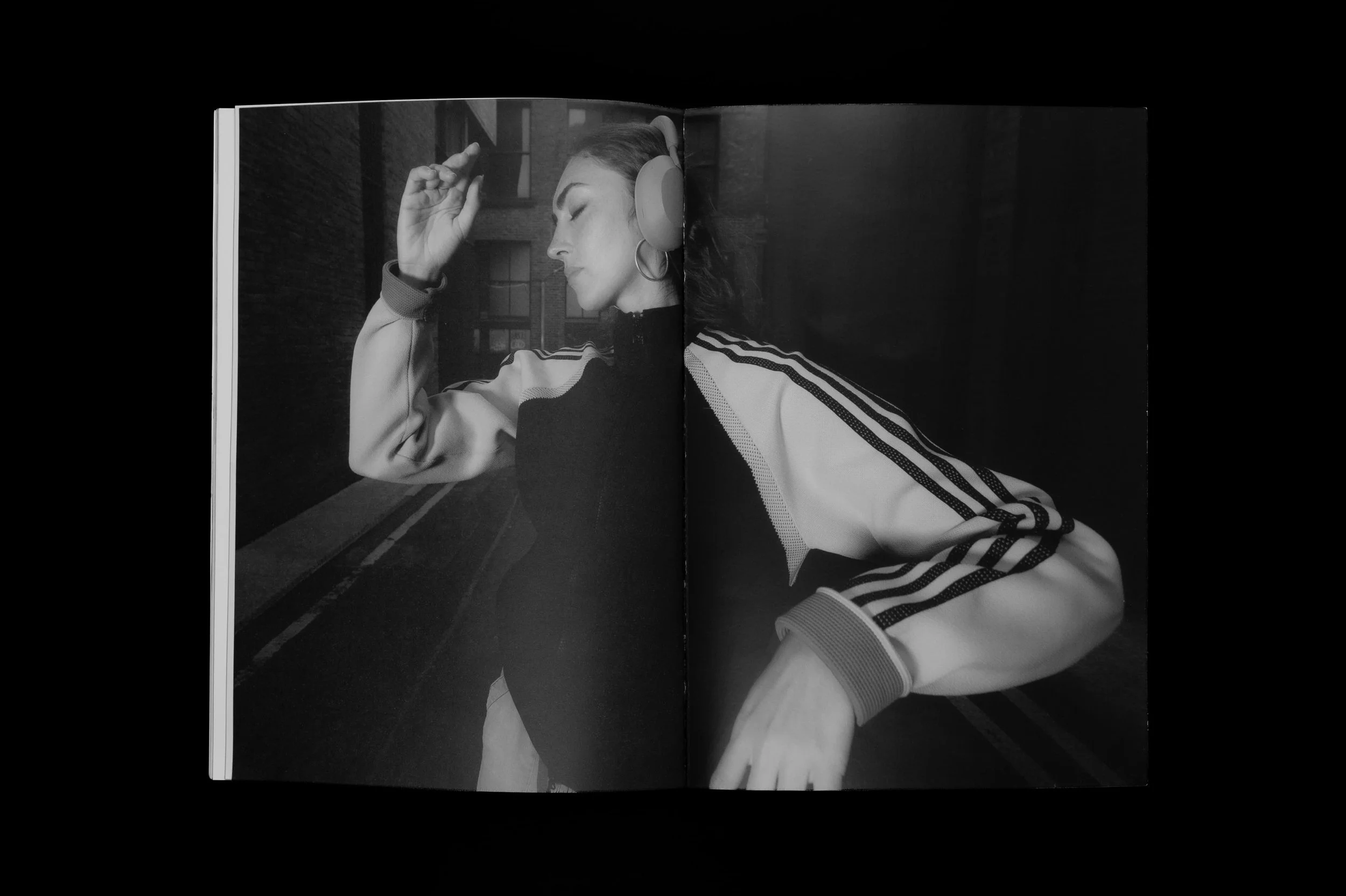 Black-and-white portrait of a woman wearing adidas clothing and headphones in the Common Frequency zine by Manchester-based photographer Yaroslav Prytula.