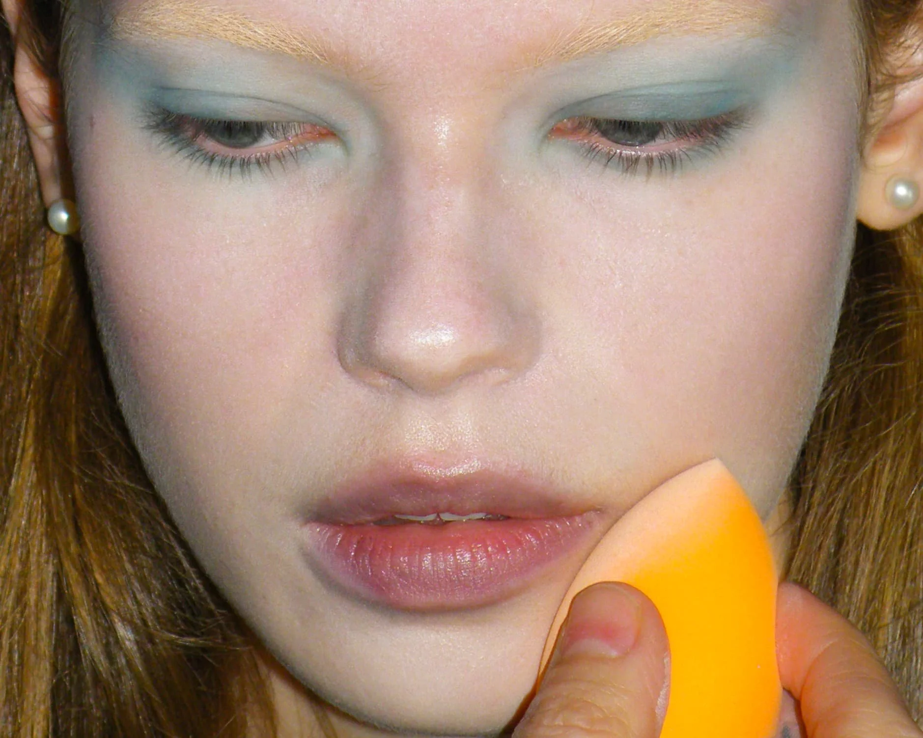 Close-up of blue and grey eye makeup being applied backstage at the Masha Popova AW26 show during London Fashion Week.