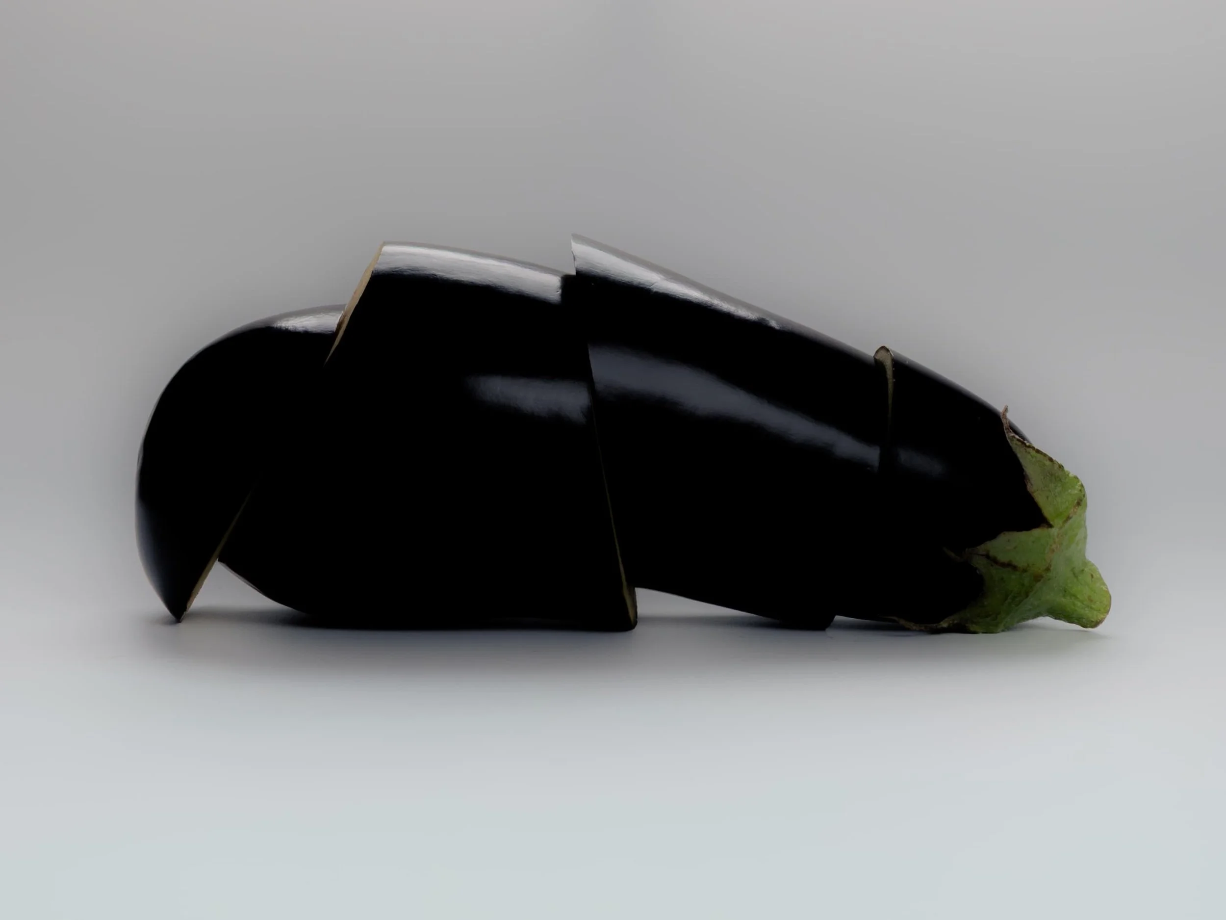 Still life photograph of a sliced aubergine arranged as an abstract sculptural composition by Yaroslav Prytula, still life photographer working across Manchester and London.
