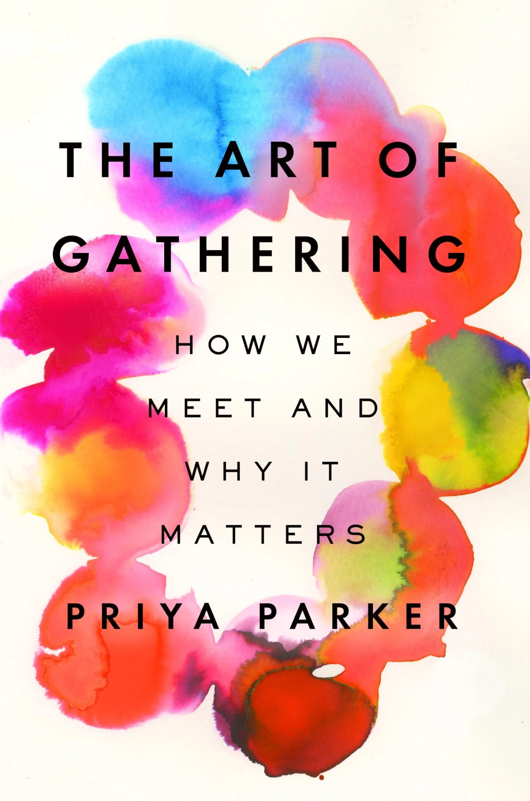 Book cover titled 'The Art of Gathering' by Priya Parker with colorful watercolor splashes in the background.