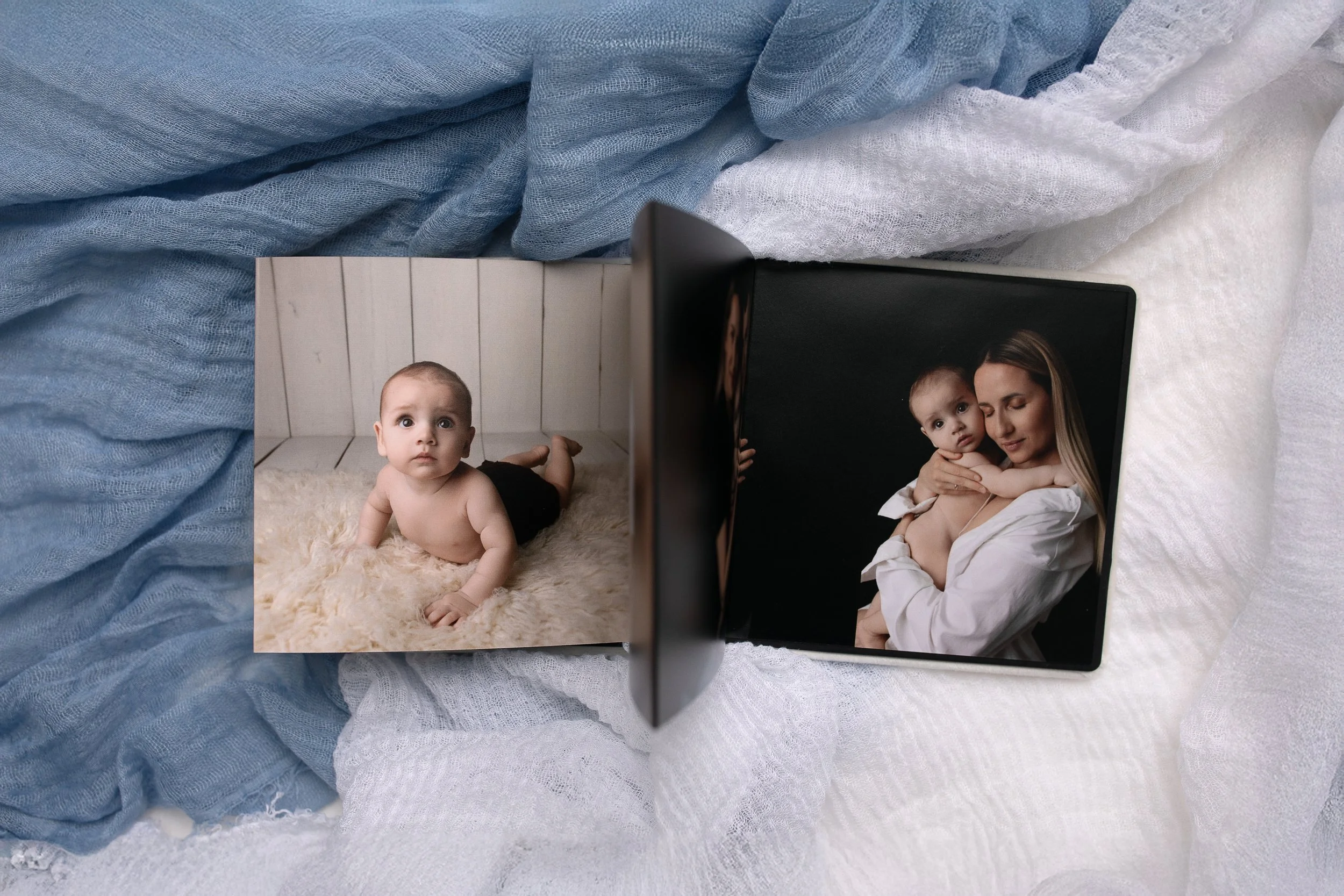 Color photograph of a motherand one baby boy, posed together and smiling. 