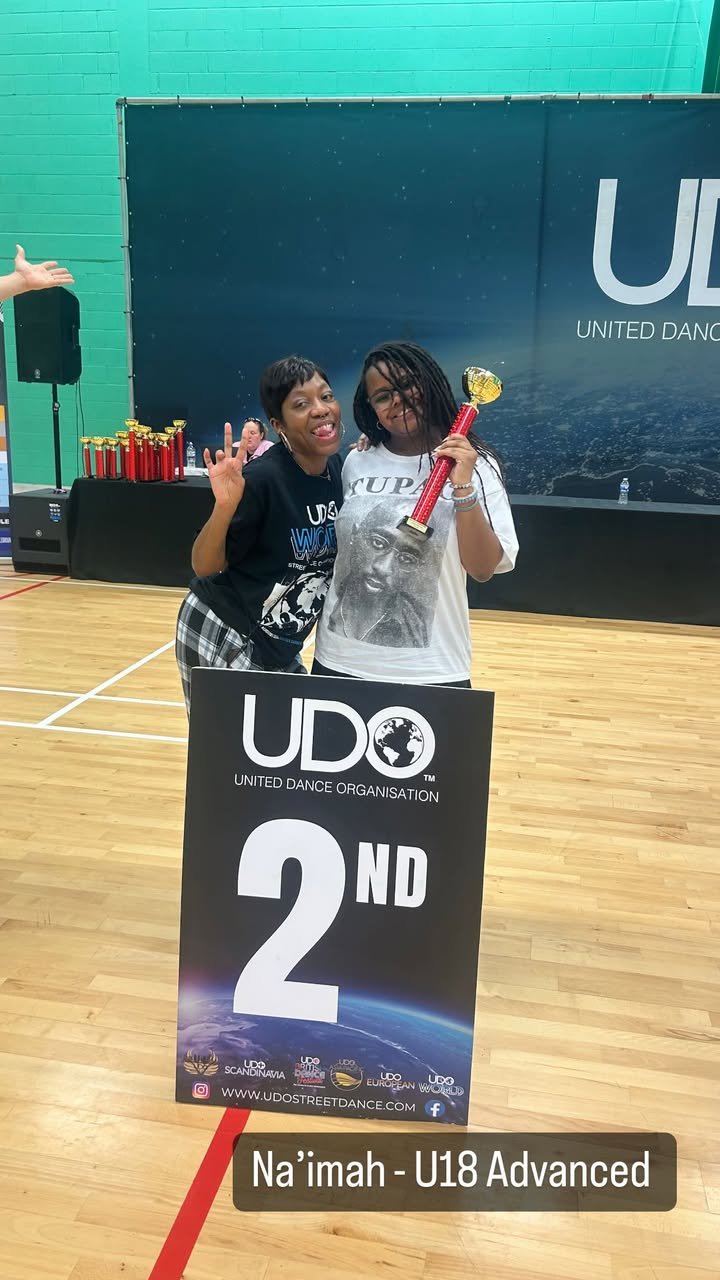 Na'imah Receiving Trophyโ 2nd place in Under 18 Advanced at UDO Greater London 2025