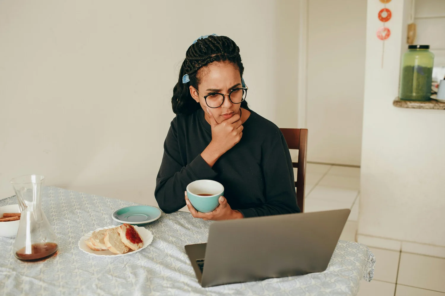 Person thinking at laptop