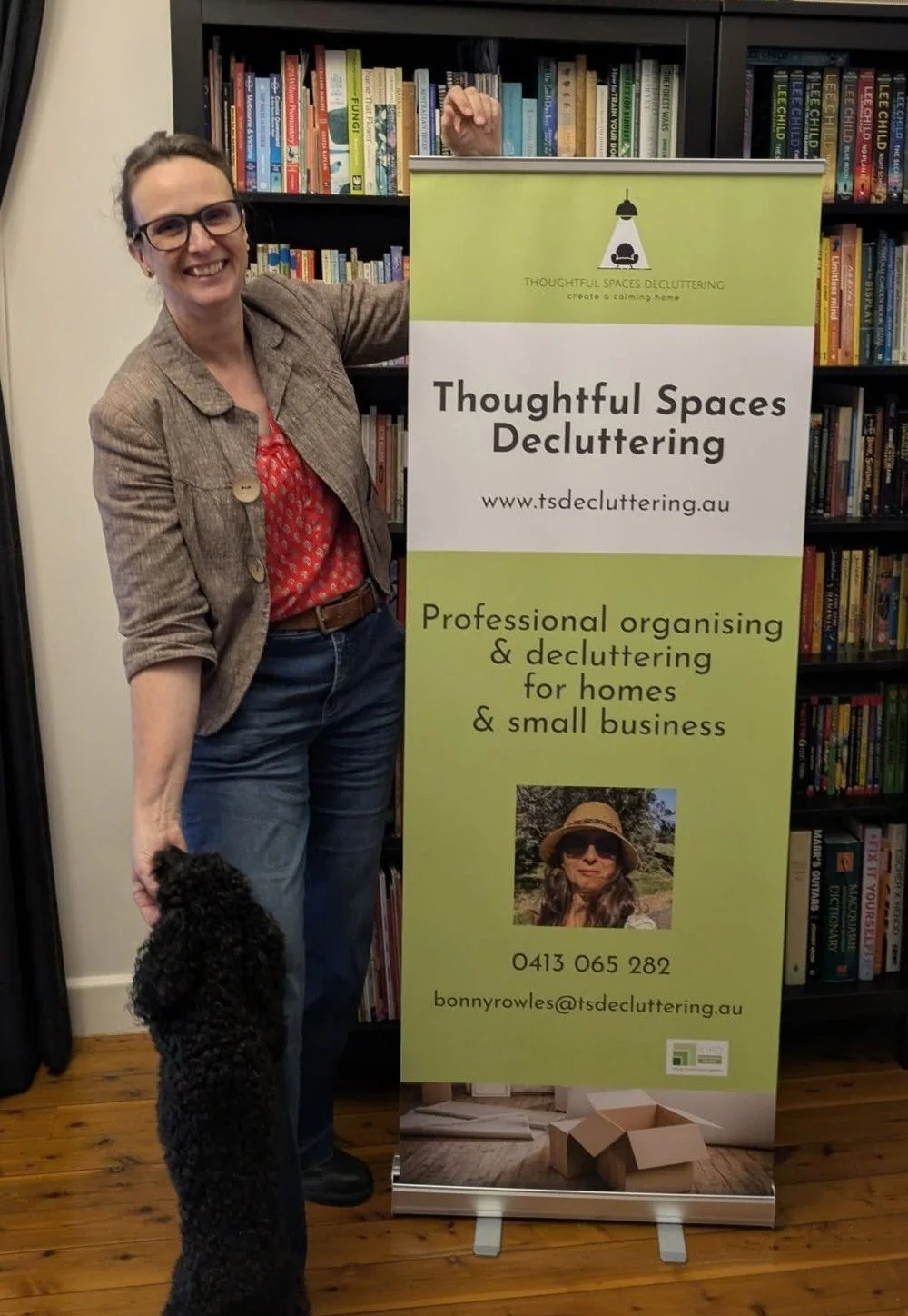 Bonny founder Thoughtful Spaces Decluttering with her banner and pet Noodles the poodle