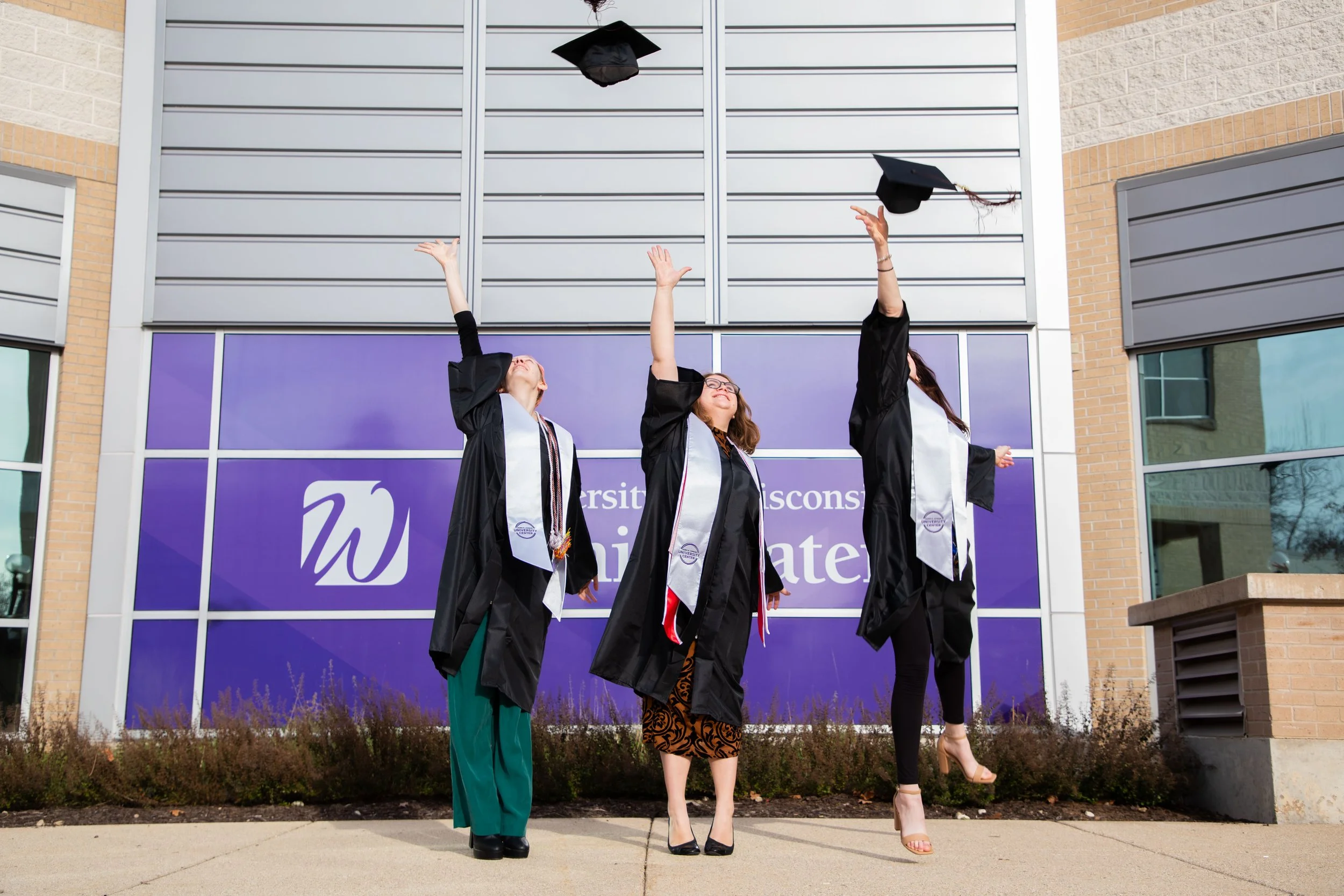 UWW's University Center's Student Employees, Class of December 2023, featured in front of the University Center.