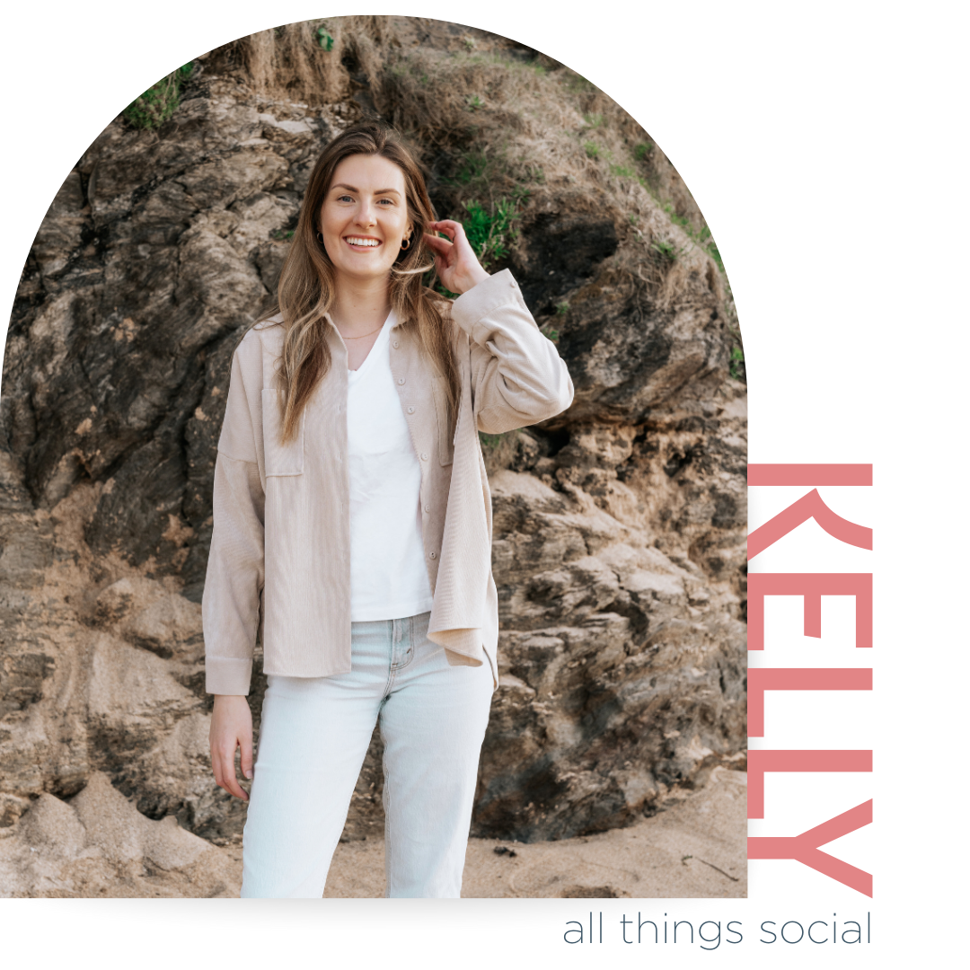 A woman smiling and standing outdoors on sandy ground with a rocky background, wearing a beige jacket and white top, with pink and black text to the right that says "KELLY" and smaller text below that says "all things social."