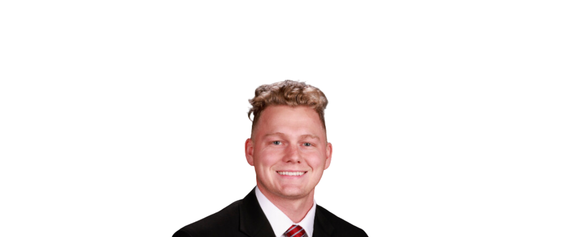 Smiling man in a suit with a striped tie on a black background.
