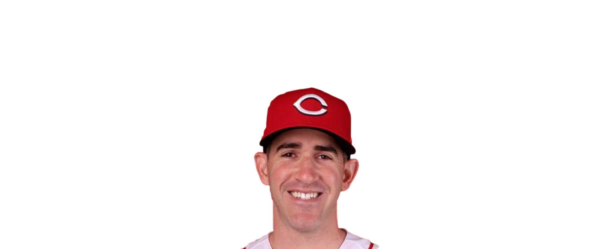 Man wearing a red baseball cap with a white "C" logo, smiling in front of a black background.