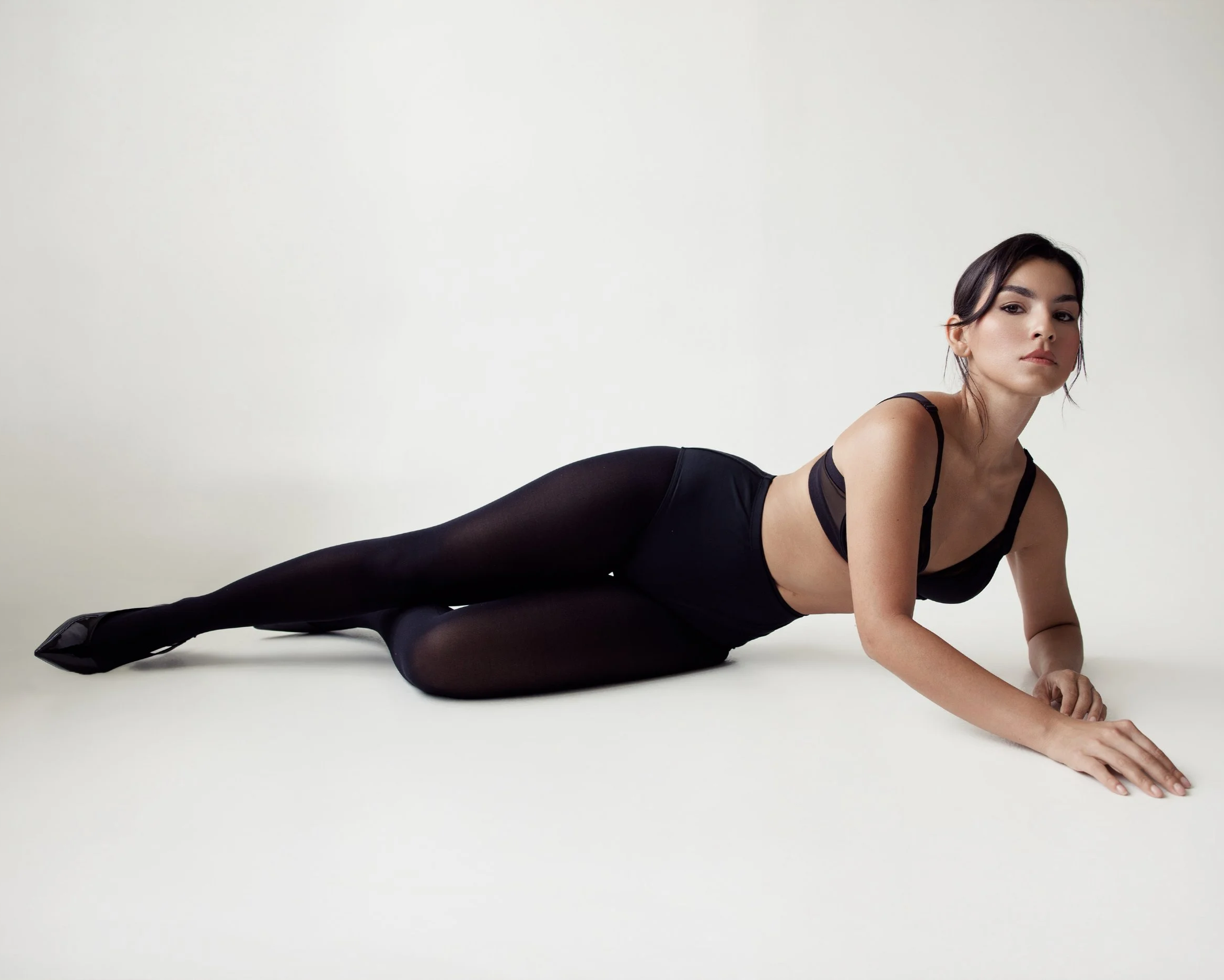 Ninah Caquias wearing a black lingerie set in a Houston studio shot
