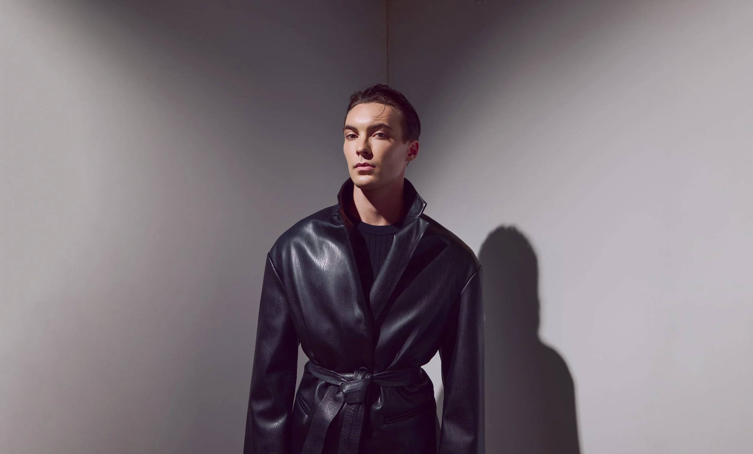 Austin model Wyatt McGlaun in a studio wearing a tailored black look