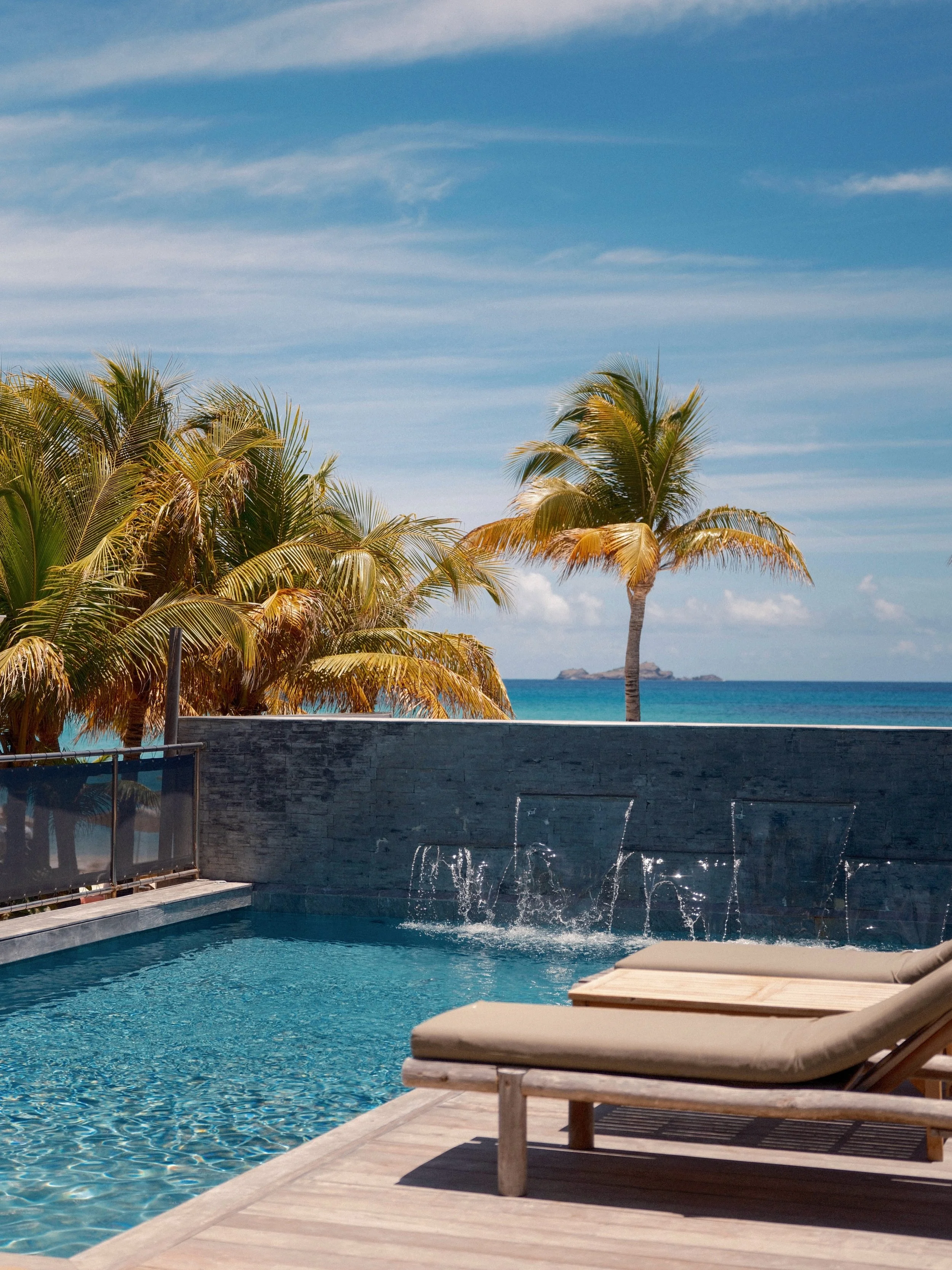 Poolside, with the Caribbean Sea on the horizon. 

Slow days at Pearl Beach Hotel, where the pool meets the ocean.