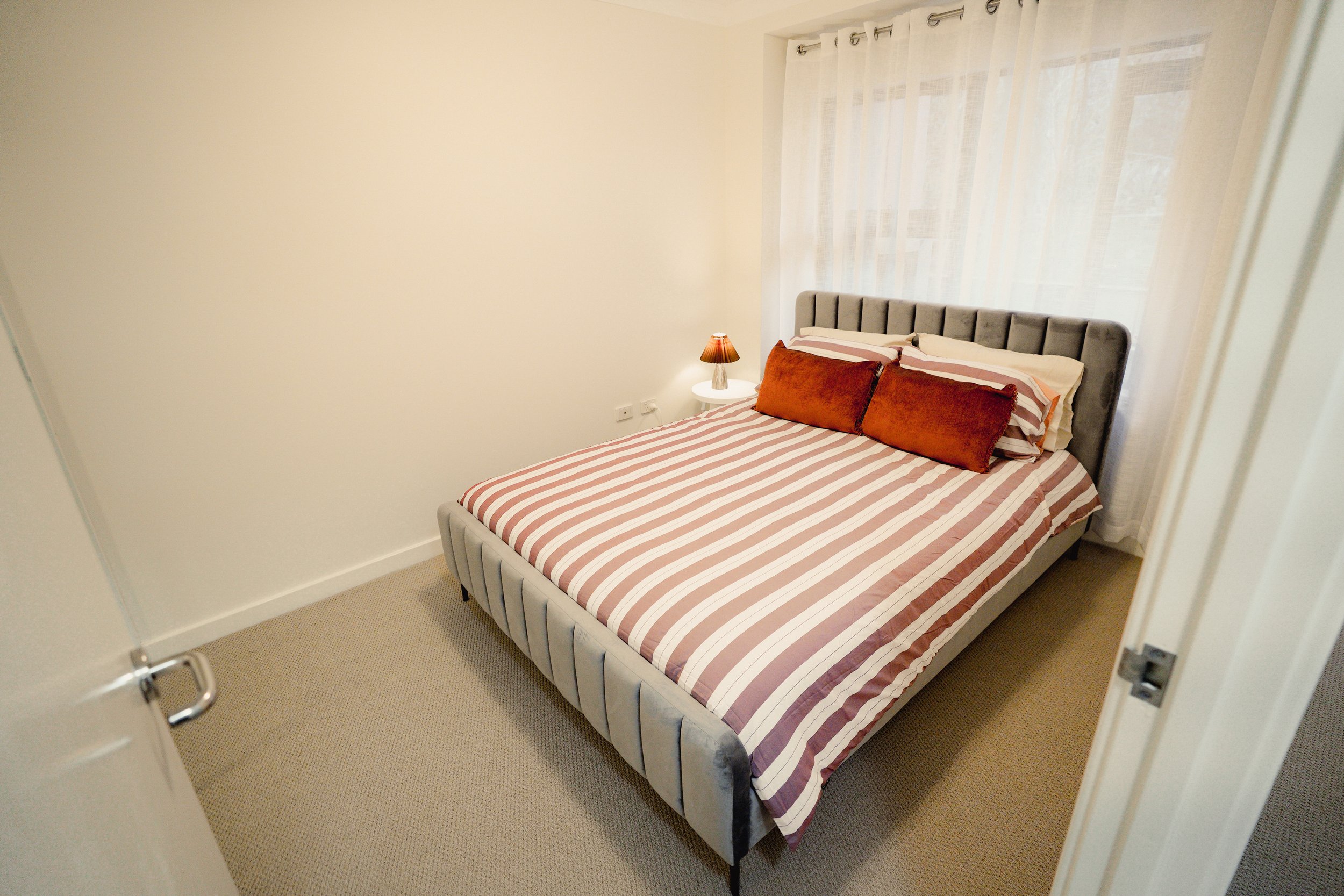 Zen Haus bedroom with a comfortable queen bed, soft linens and calming Japandi-inspired design.