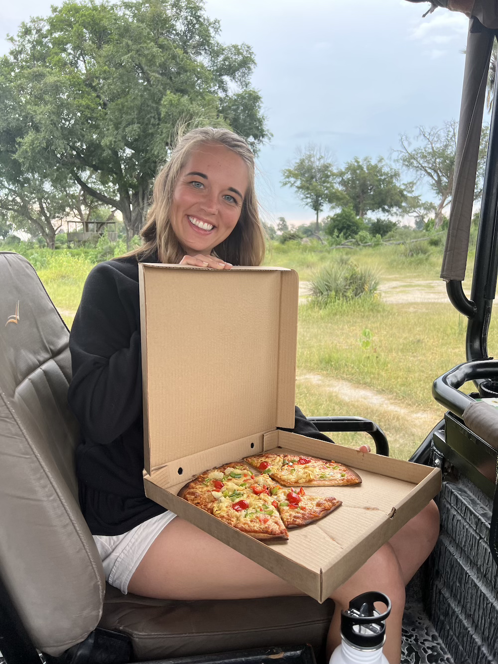 Maura Postlethwait enjoying gluten free pizza at Mombo Camp in Botswana.