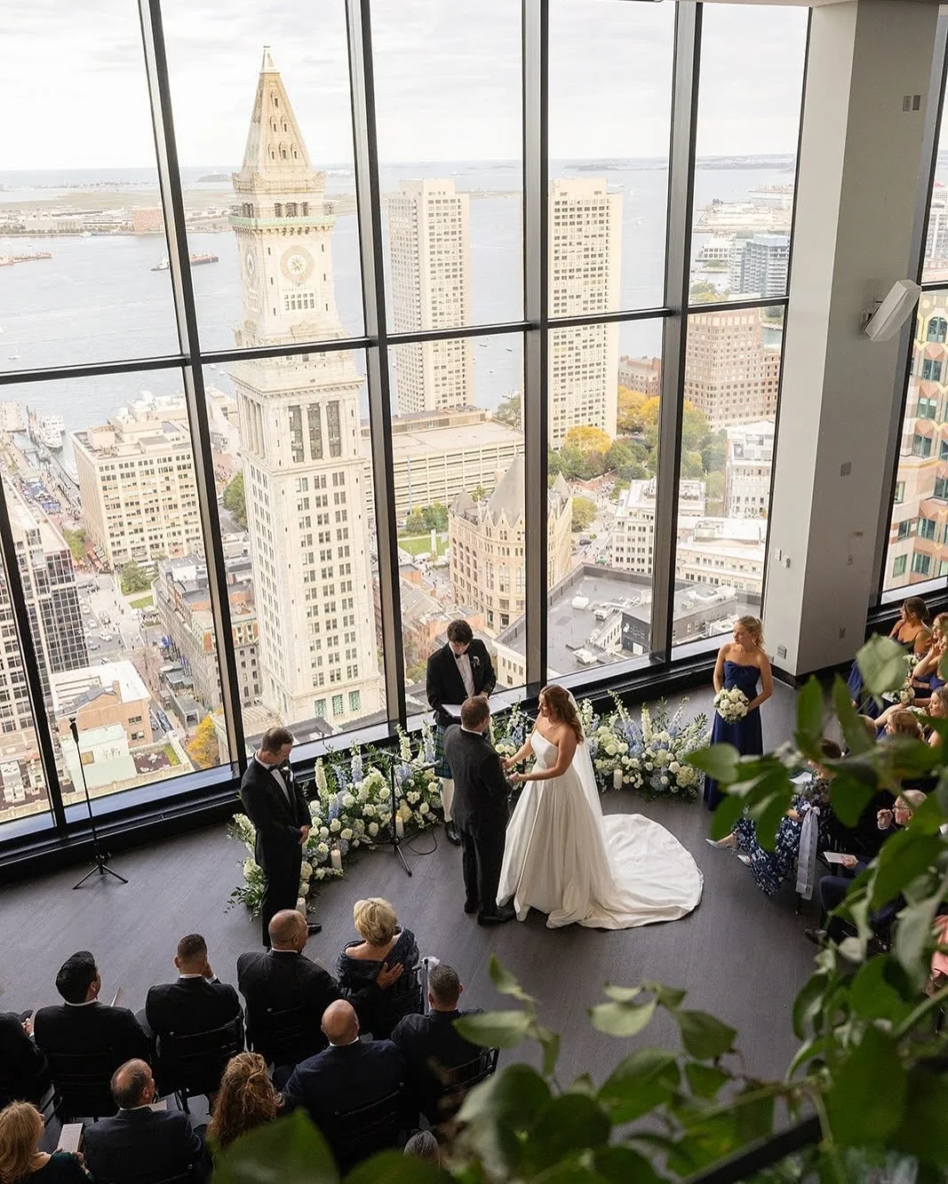 I absolutely adore this ceremony design when saying I do at the State Room. The low and lush grounded arc creates a romantic ambiance while letting that iconic Boston skyline really show through. Not to mention these are amazing for reuse during the 