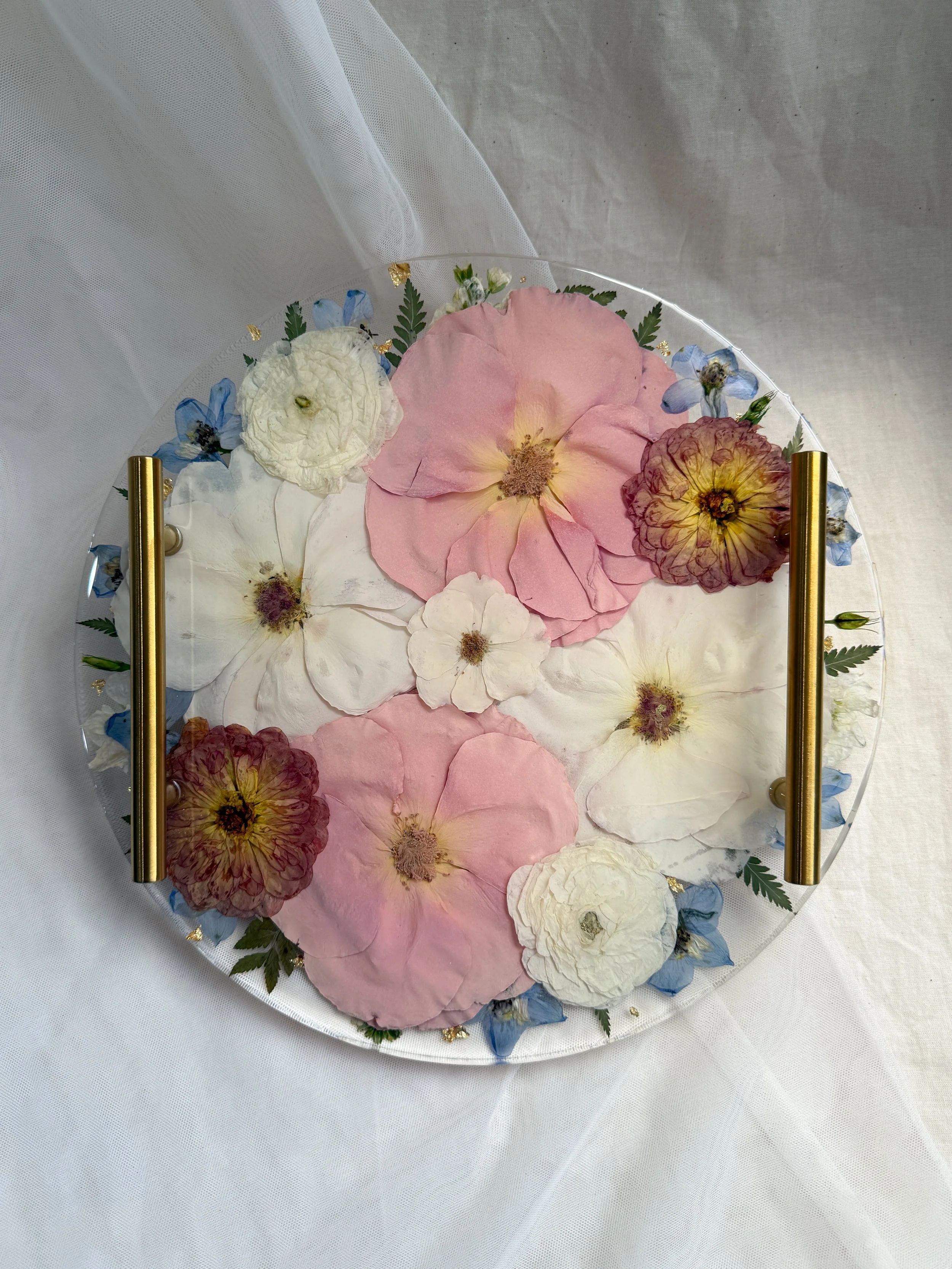 12-inch circle resin tray with gold handles preserving blush, ivory, white, and burgundy flowers with blue accents