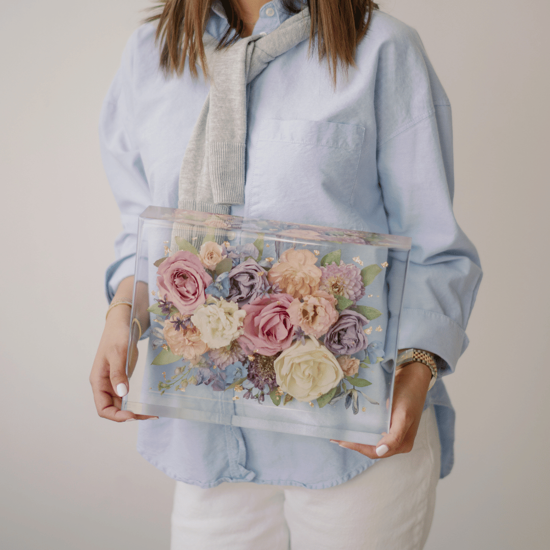 Vivian of VIVIAN x CO holding a custom preserved flower display box