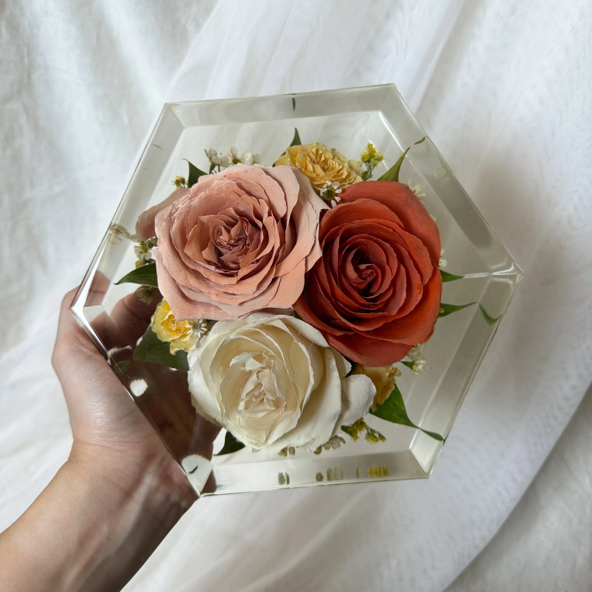 6-inch resin hexagon preserving blush, orange, and ivory roses with greenery and small yellow flowers