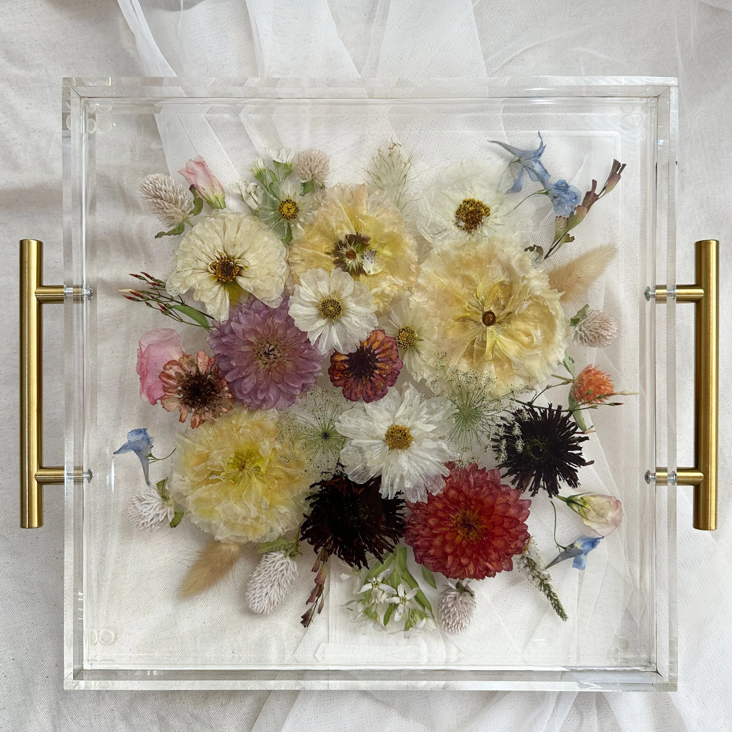 12-by-12-inch acrylic tray with offset gold handles preserving white, pale yellow, pink, burgundy, and coral flowers with blue accents