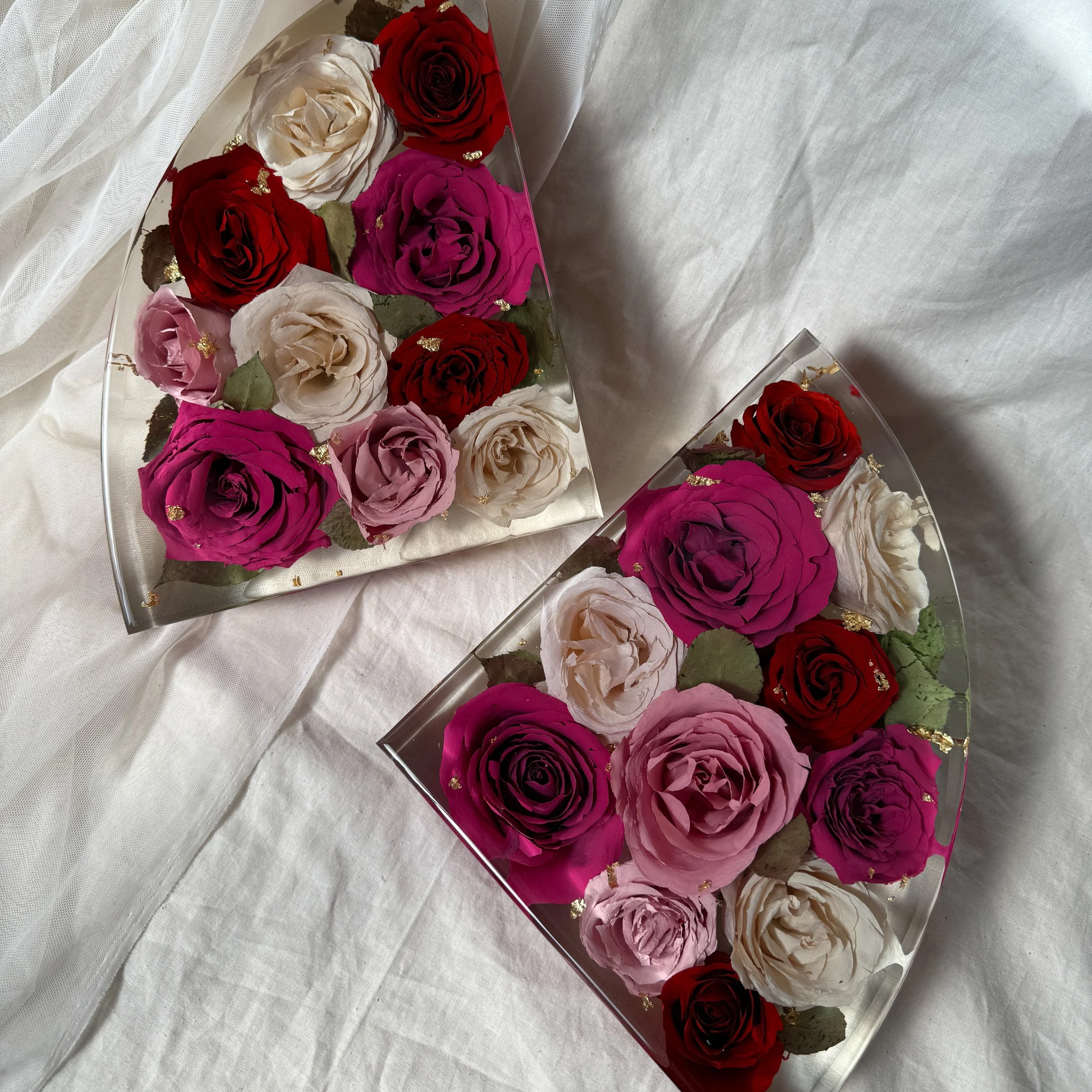 Pair of 9-inch resin bookends preserving red, fuchsia, blush, and ivory roses