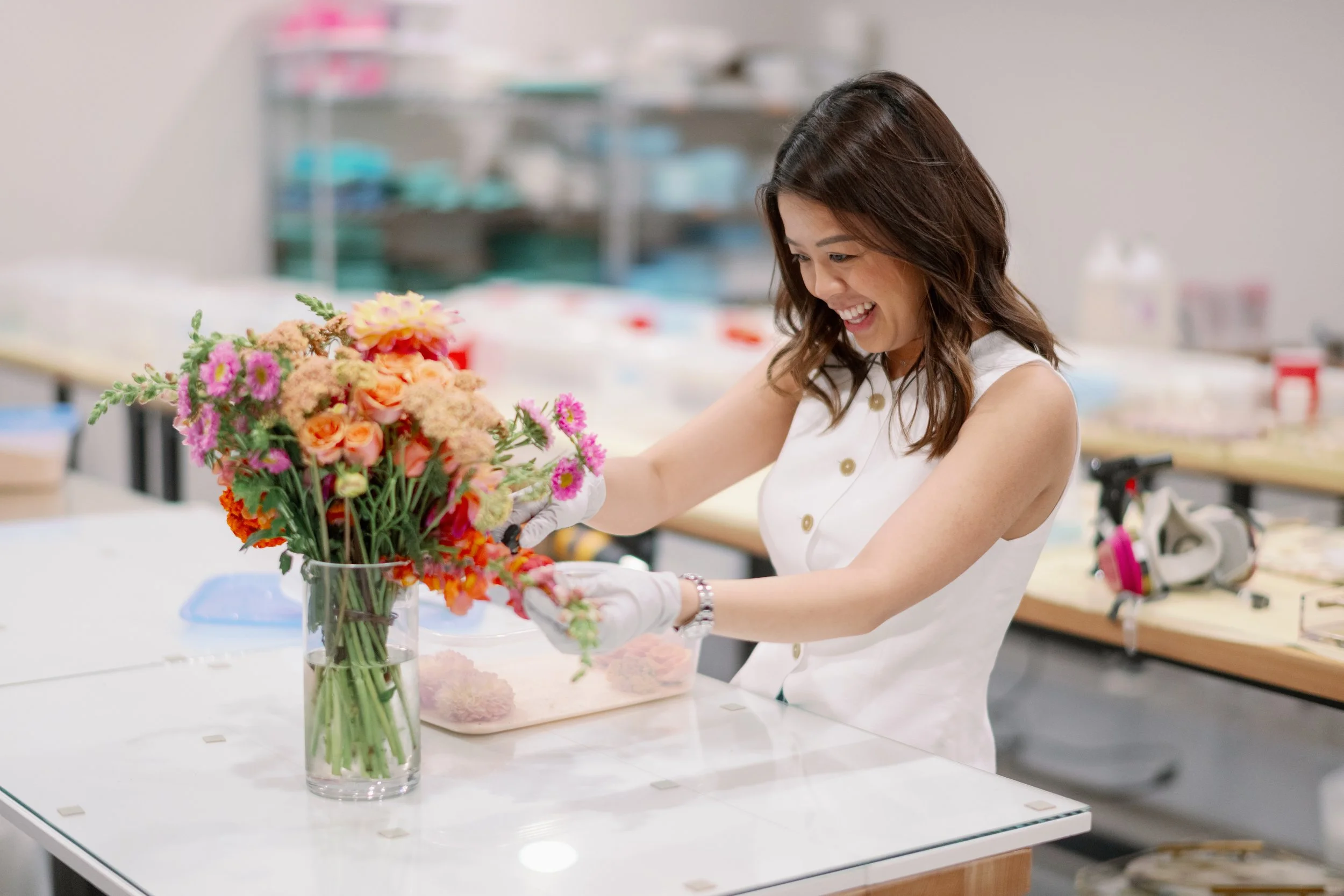 Vivian, owner of VIVIAN x CO, preserving a colorful wedding bouquet in her Chicago studio