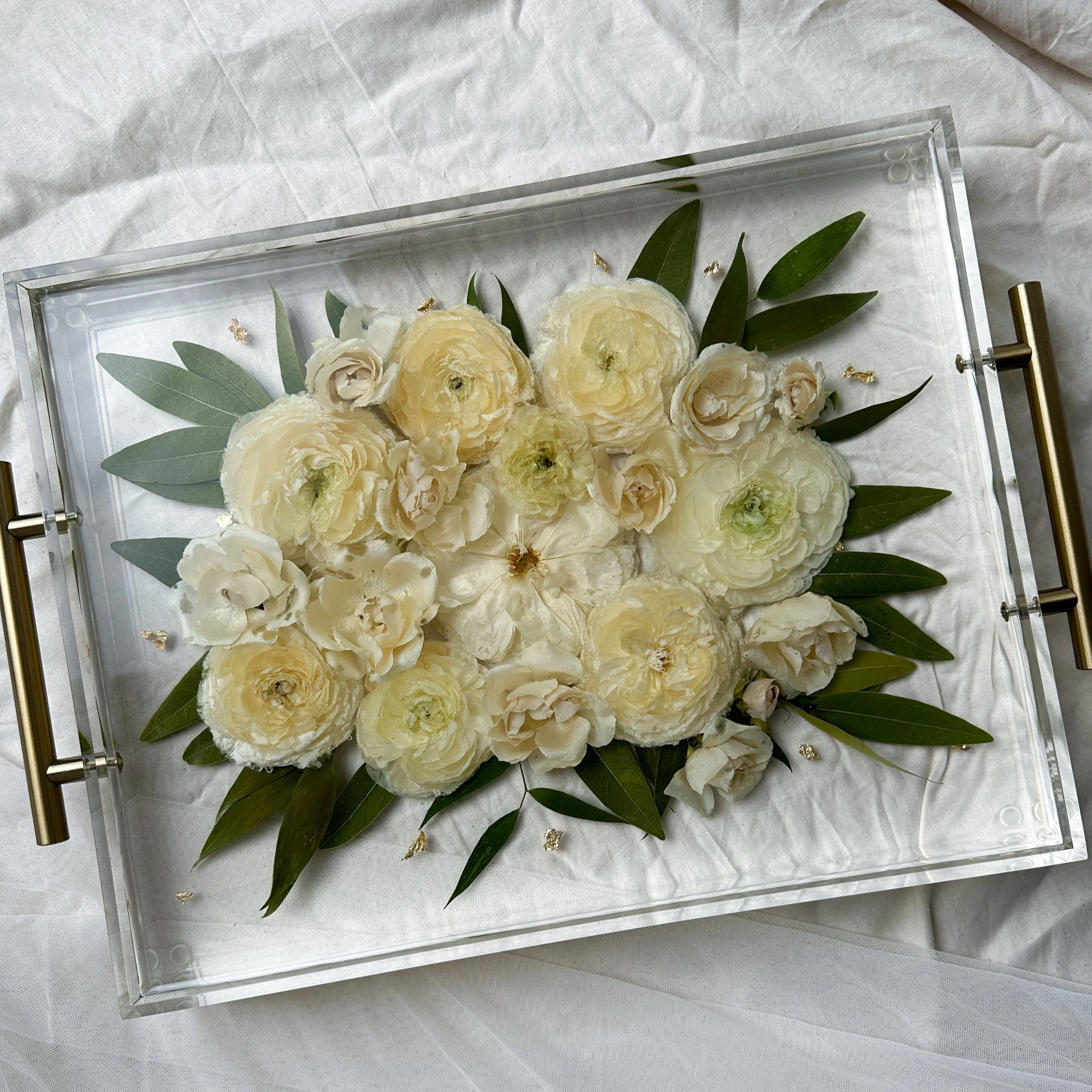 11-by-14-inch acrylic tray with silver handles featuring preserved ivory roses surrounded by dark green leaves