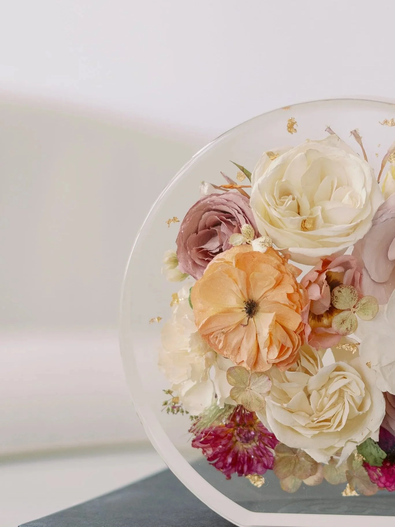 Preserved bouquet of white, pink, and peach roses with gold leaf accents