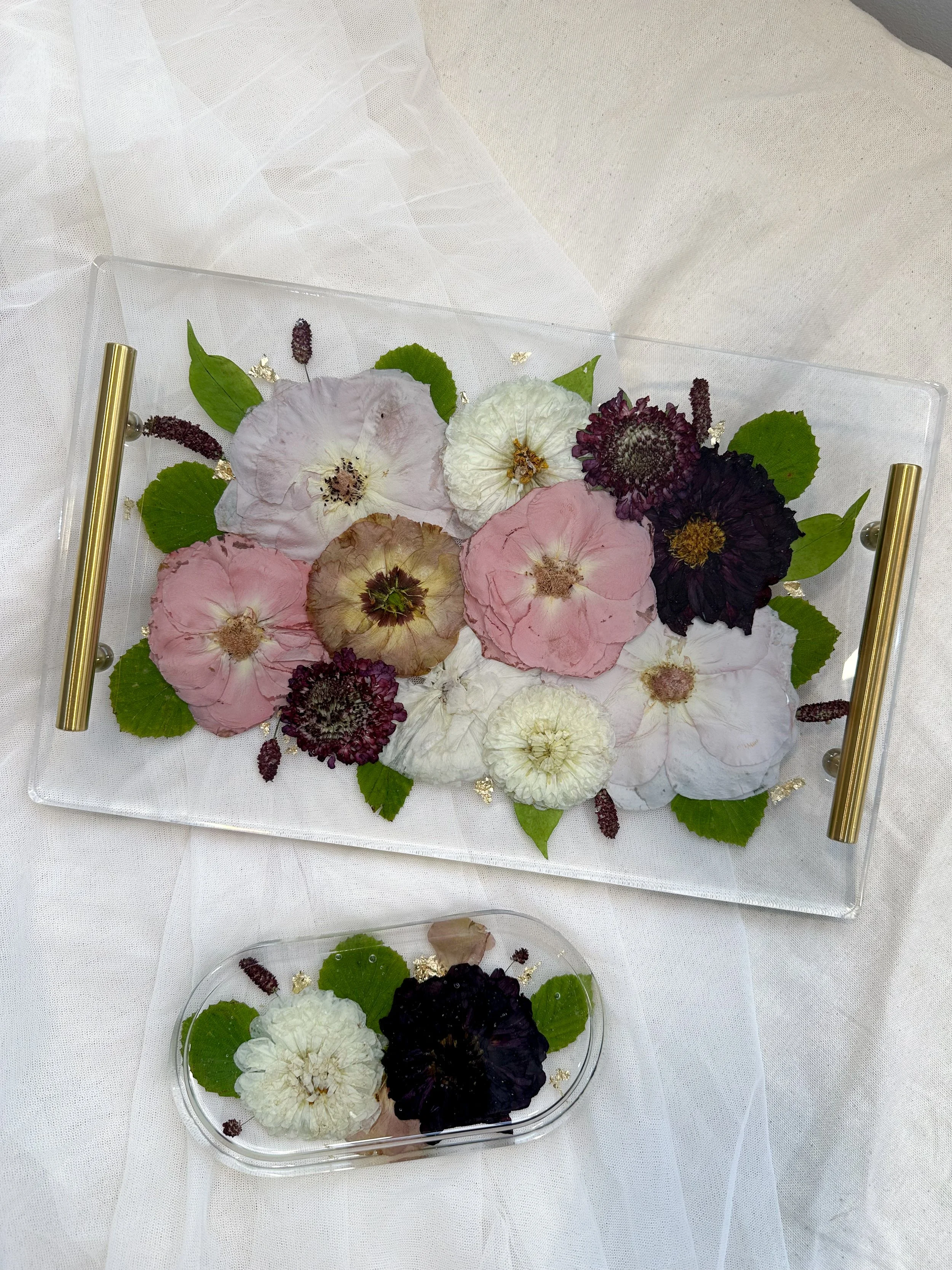 Custom resin flower tray preserving blush, ivory, burgundy, and dark purple flowers with greenery