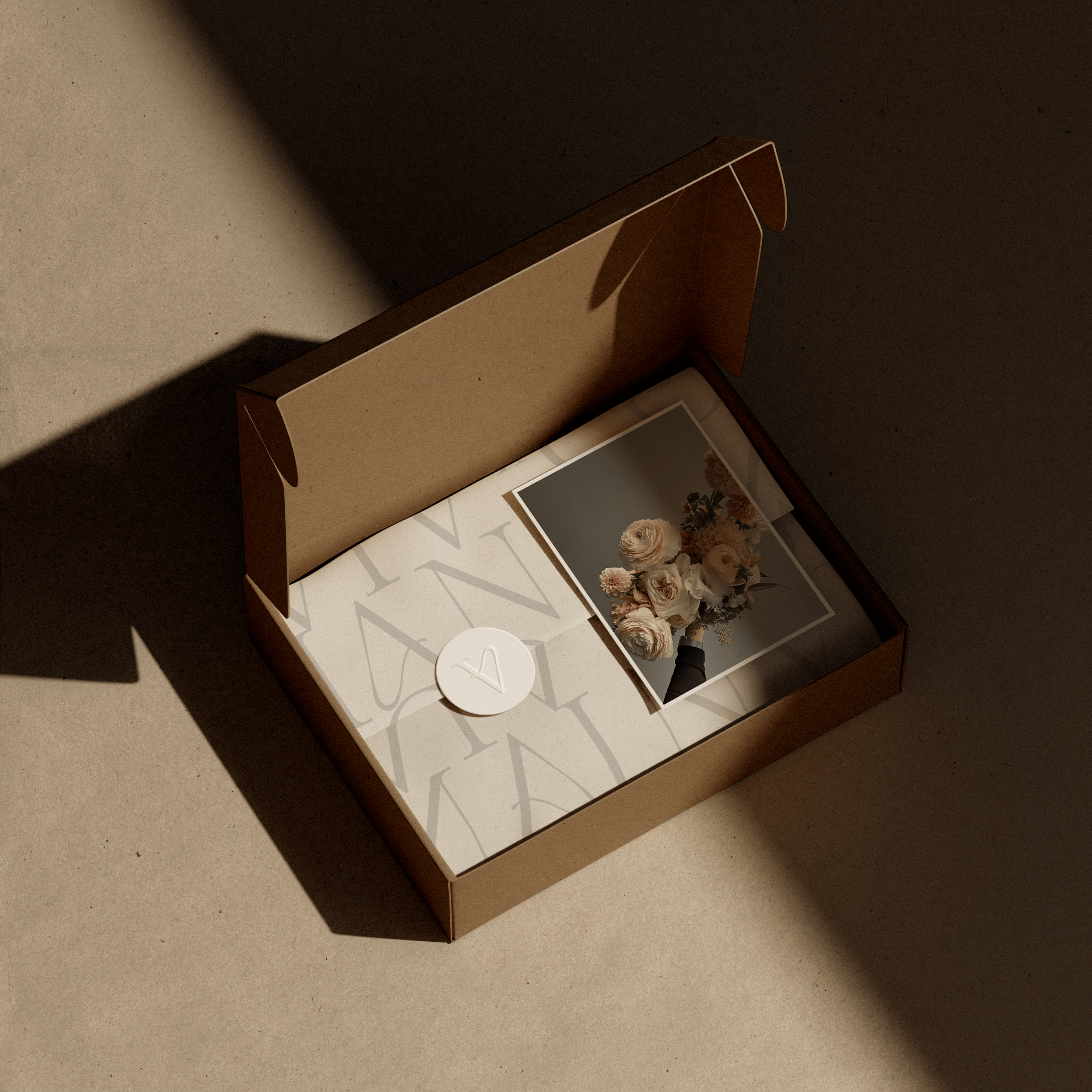 Open floral preservation packaging box displaying framed preserved flowers and printed materials