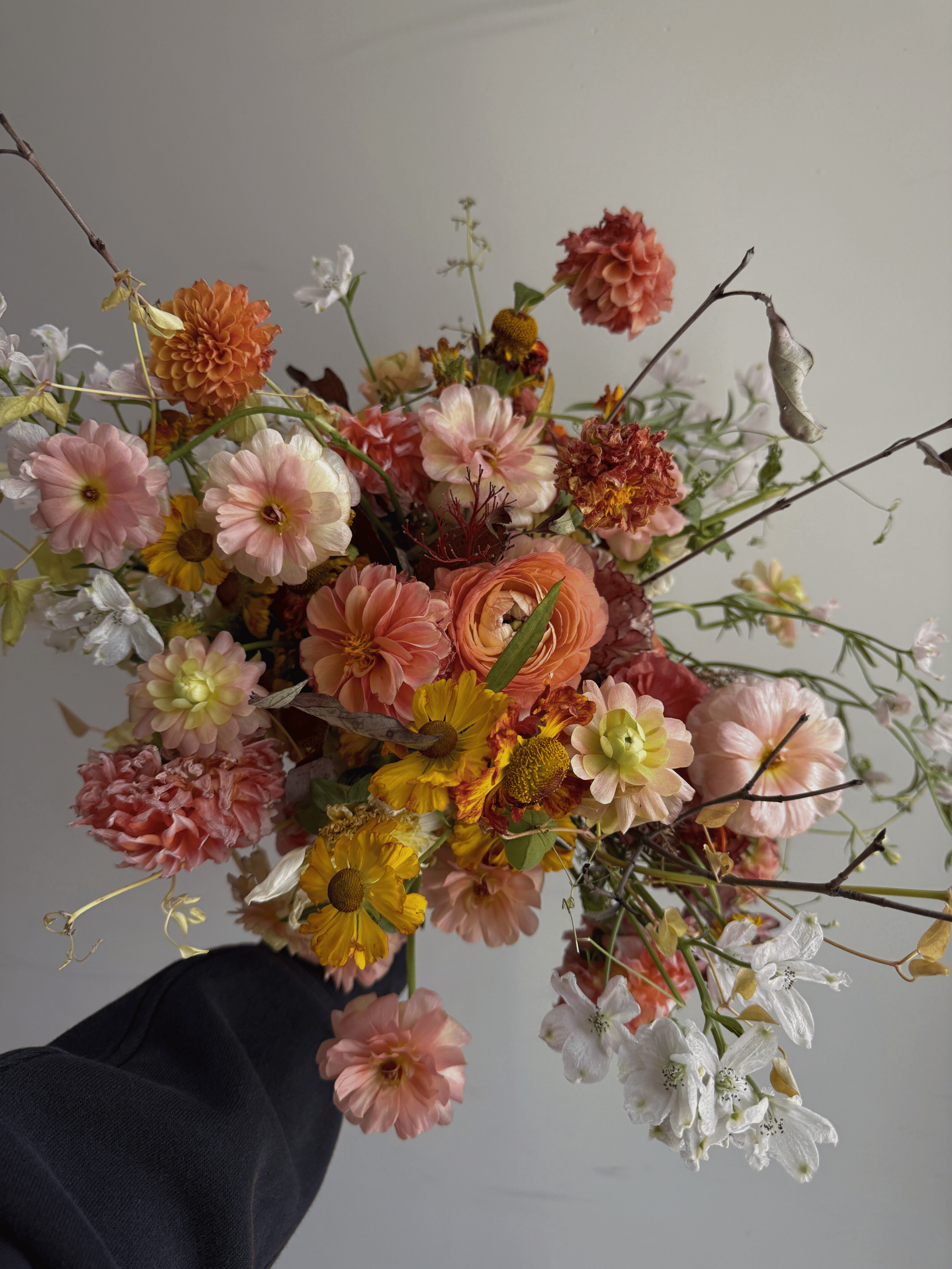 Colorful wedding bouquet with pink, orange, yellow, and white flowers ready for preservation