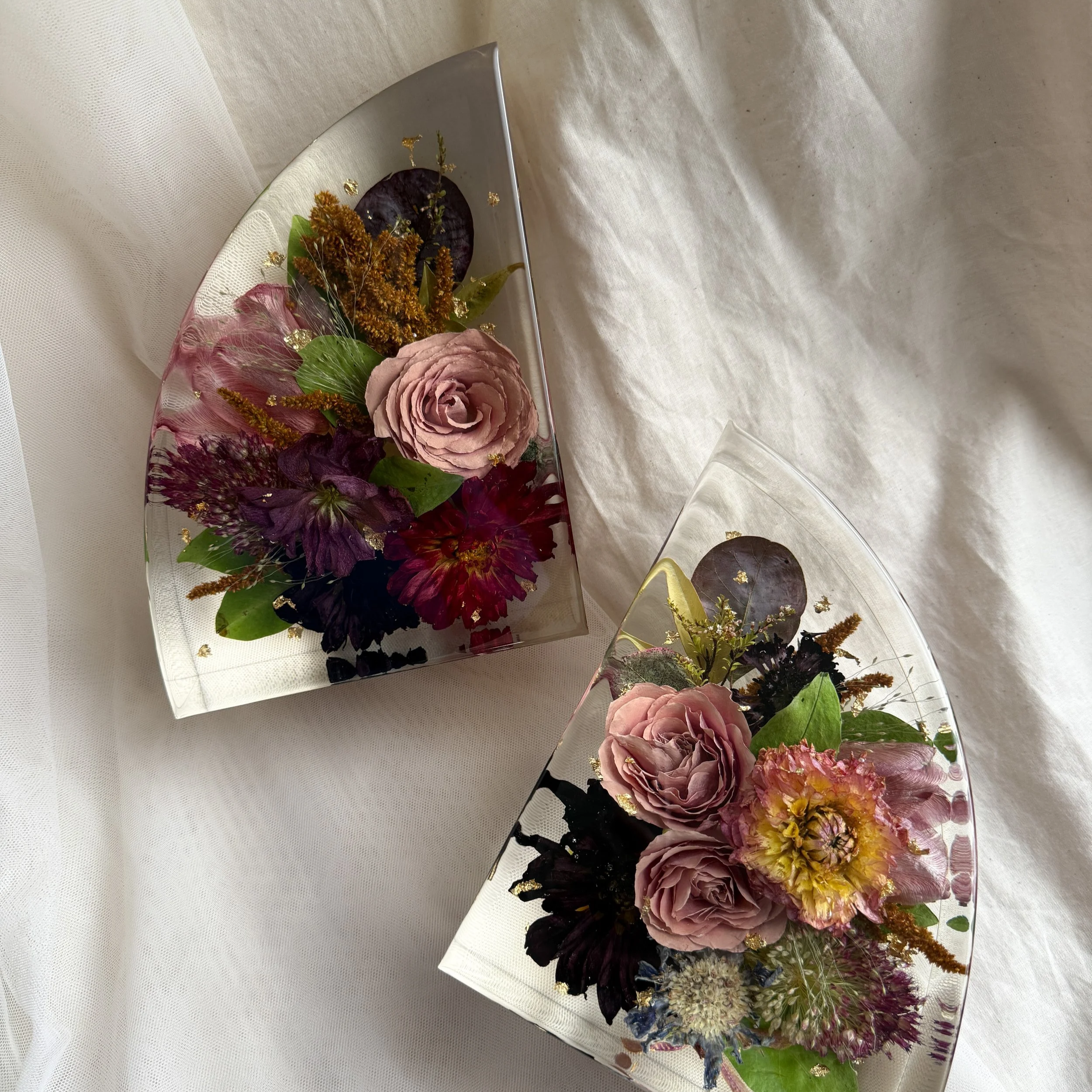 Pair of 7-inch resin bookends featuring preserved purple, pink, burgundy, and orange flowers