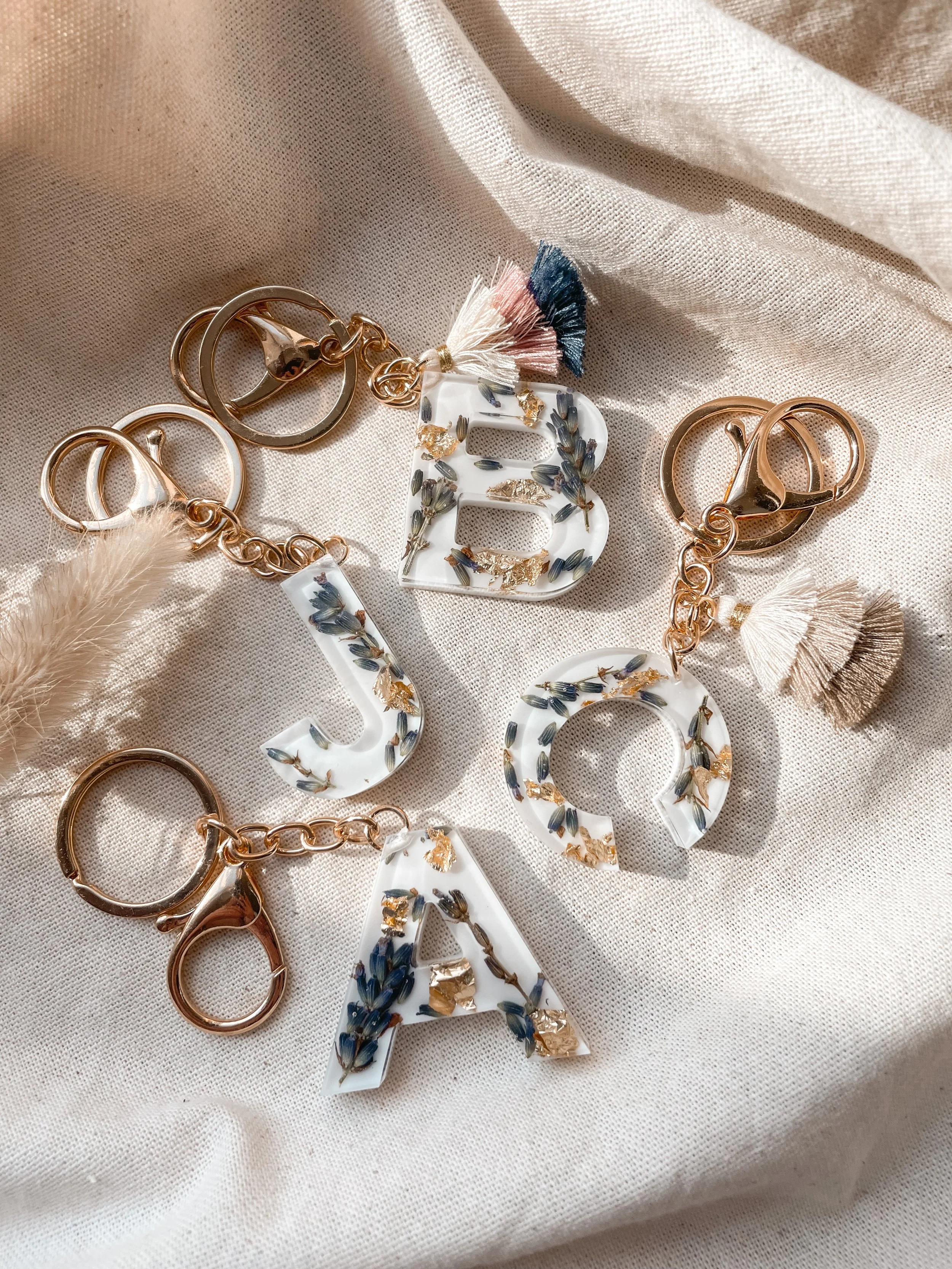 Resin letter keychains preserving lavender with gold-tone key rings