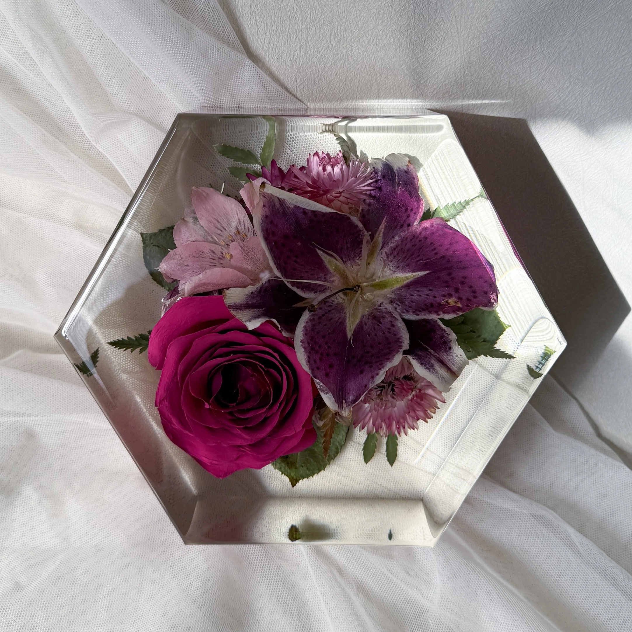 6-inch resin hexagon preserving a deep pink rose with large purple lily and blush flowers