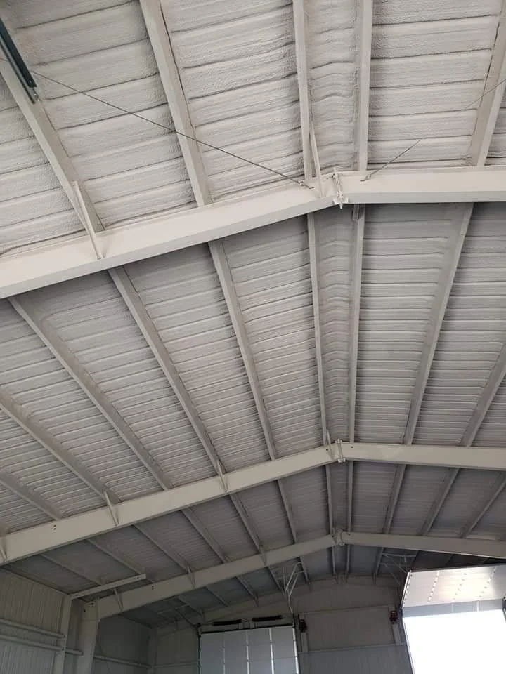 Interior view of a white metal building after receiving expertly applied closed-cell spray foam applied by Southwest Florida's experts in metal building insulation