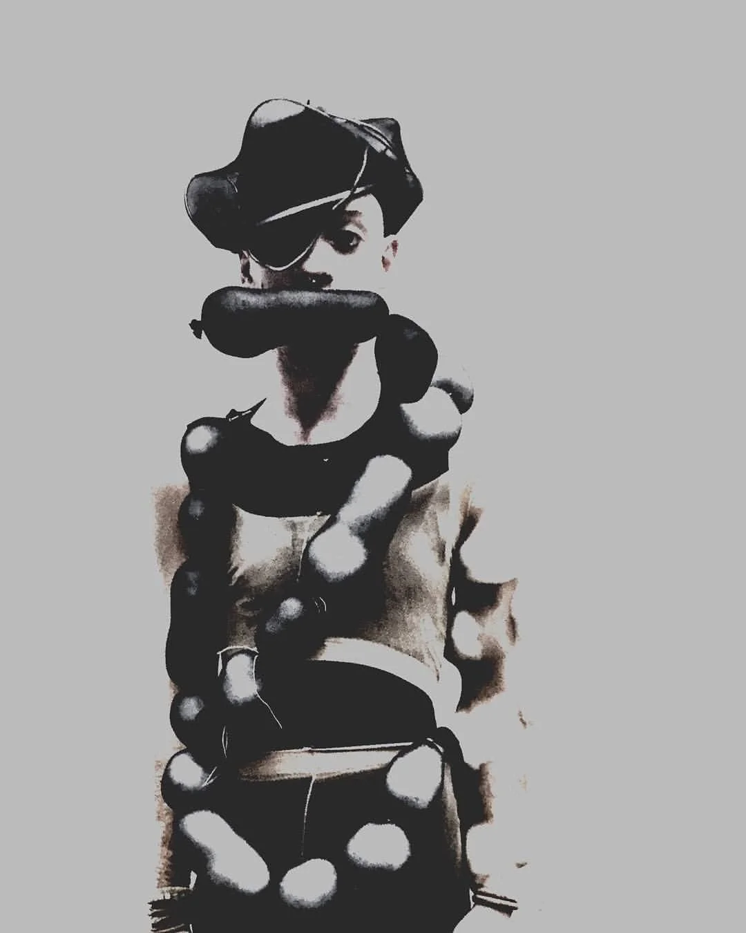 Stylized black and white digital art of a young man wearing a hat and a large chain necklace, with a neutral background.