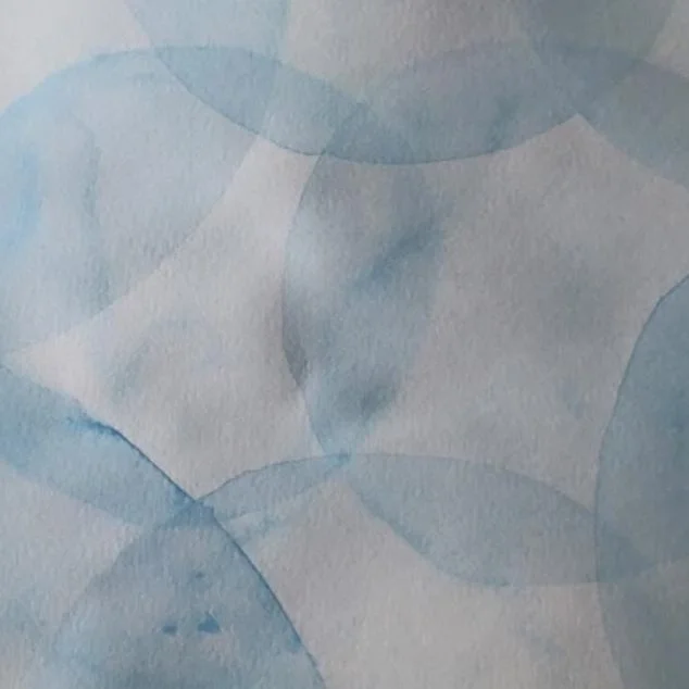 A watercolor painting with overlapping blue and light gray circles.