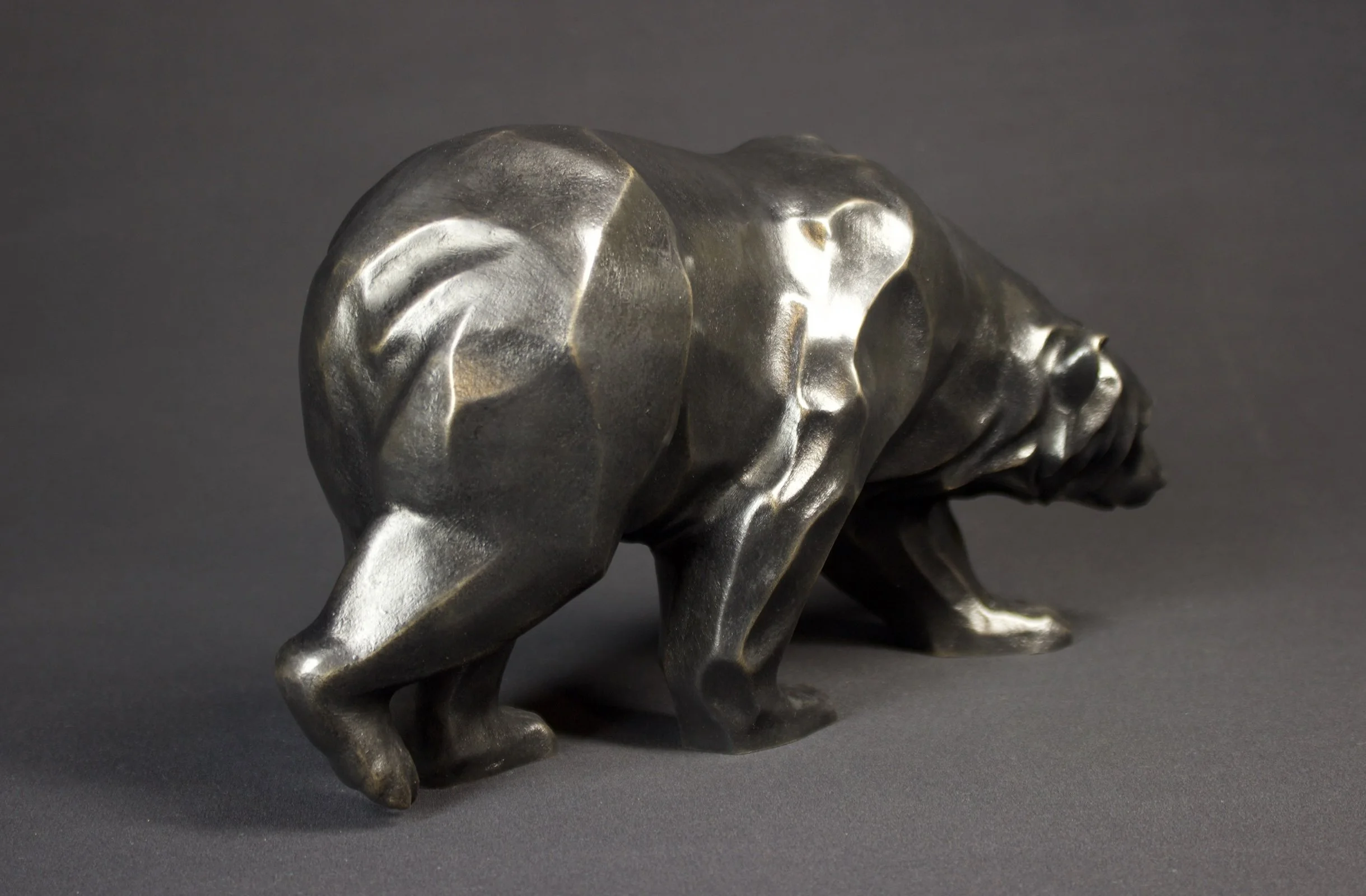 Bronze bear sculpture titled “Brother,” featuring a grounded, forward-moving posture with Italian black patina finish.
