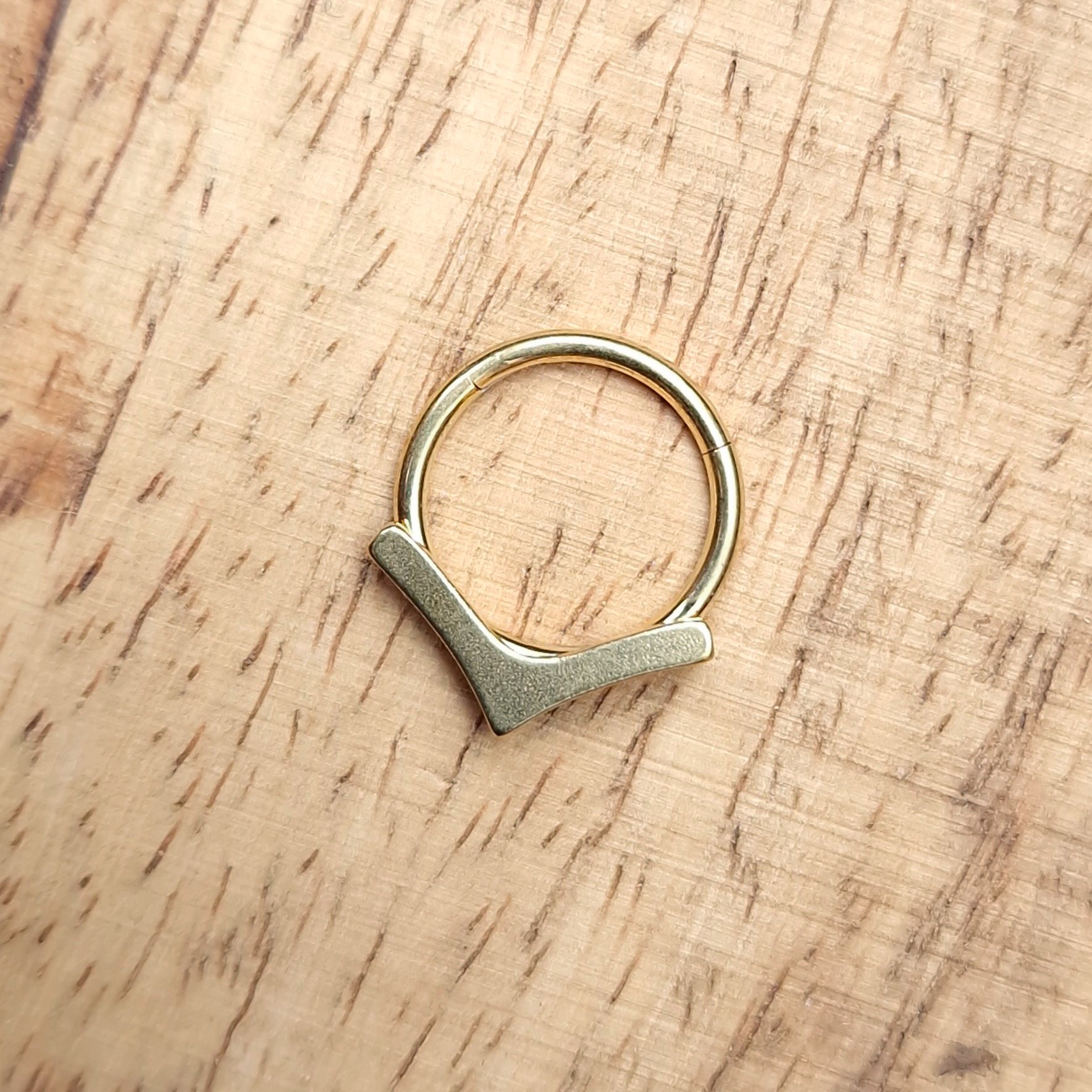 Ero's Aim titanium segment clickers, piercing ring with arrow shaped attachment. Gold PVD