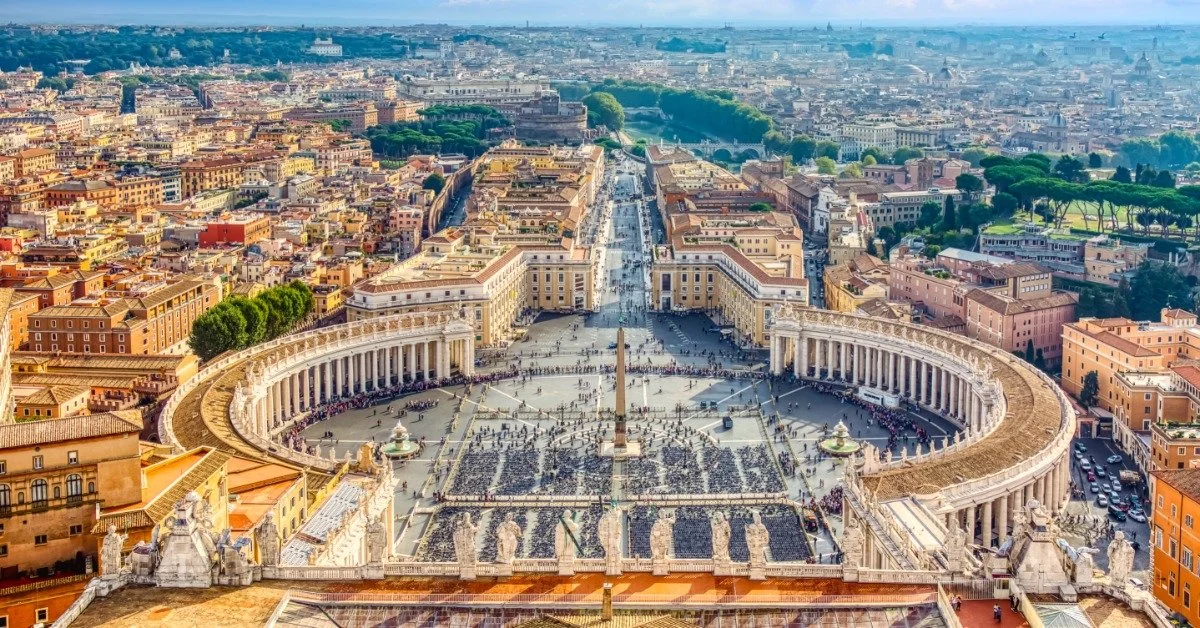 The view from the dome of St. Peter's Basilica over St. Peter's Square and the sprawling cityscape of Rome beyond.