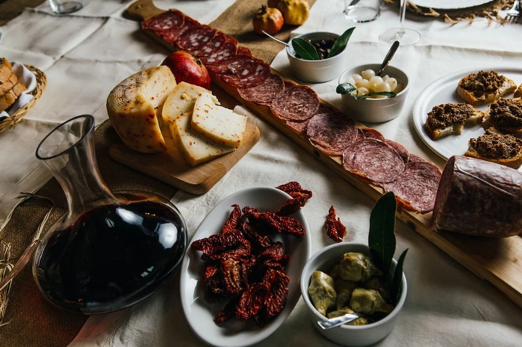 A traditional Italian antipasto spread featuring a generous selection of cured meats, artisan cheeses, and savory appetizers.