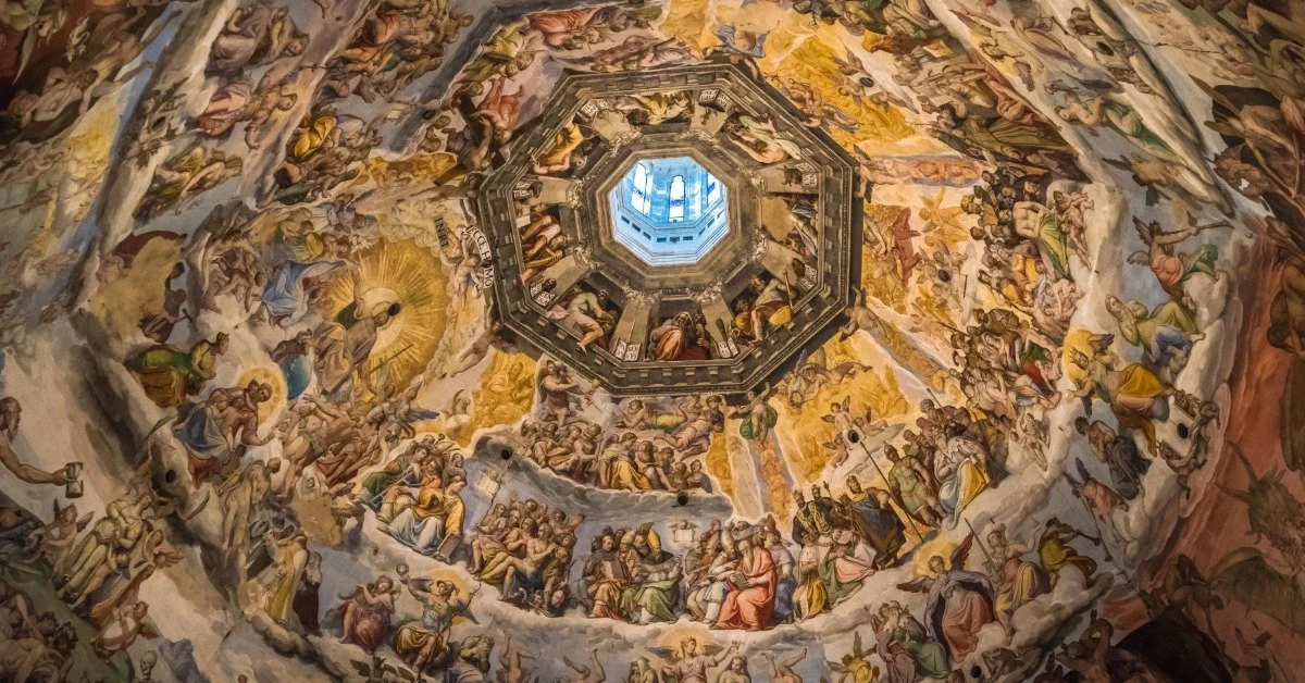 The interior of Brunelleschi's dome in Florence, with painted frescoes spiraling around the octagonal ceiling skylight.