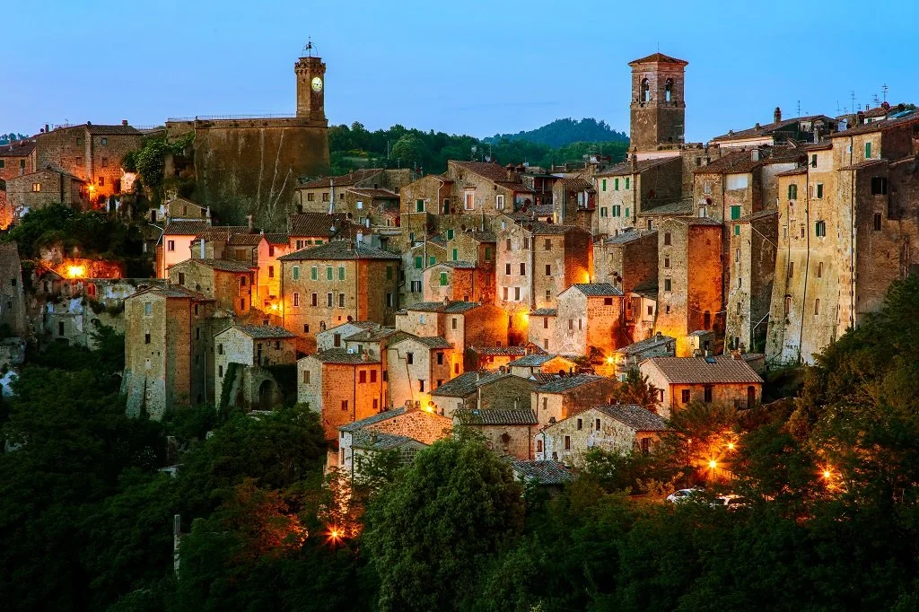 Medieval hilltop town of Sorano, with buildings carved directly into and built from soft volcanic tuff stone cliffs.