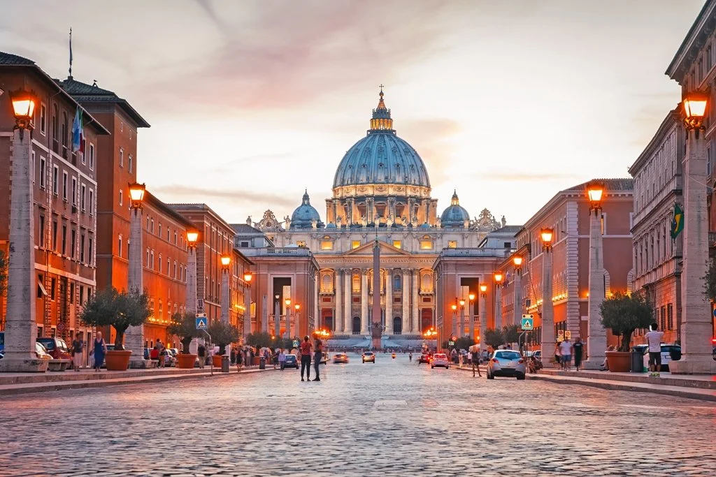 Sunset view of St. Peter's Basilica, the main papal basilica in Vatican City, photographed from the Via della Conciliazione.