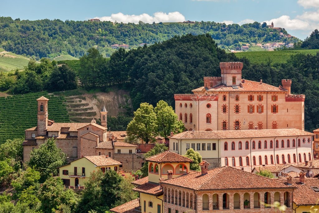 Barolo Castle (Castello Falletti di Barolo) surrounded by rolling hills and vineyards, Langhe wine region of Piedmont, Italy.