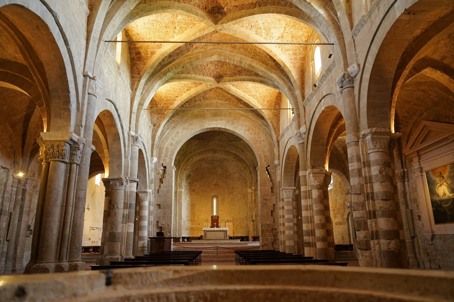 Interior of the Sovana Cathedral, a remarkable example of Romanesque-Gothic architecture in the Maremma region.