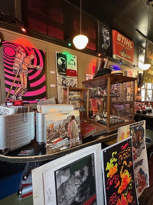 Vintage vinyl & psychedelic posters beneath the far out art wall by Tacoma's James Hume